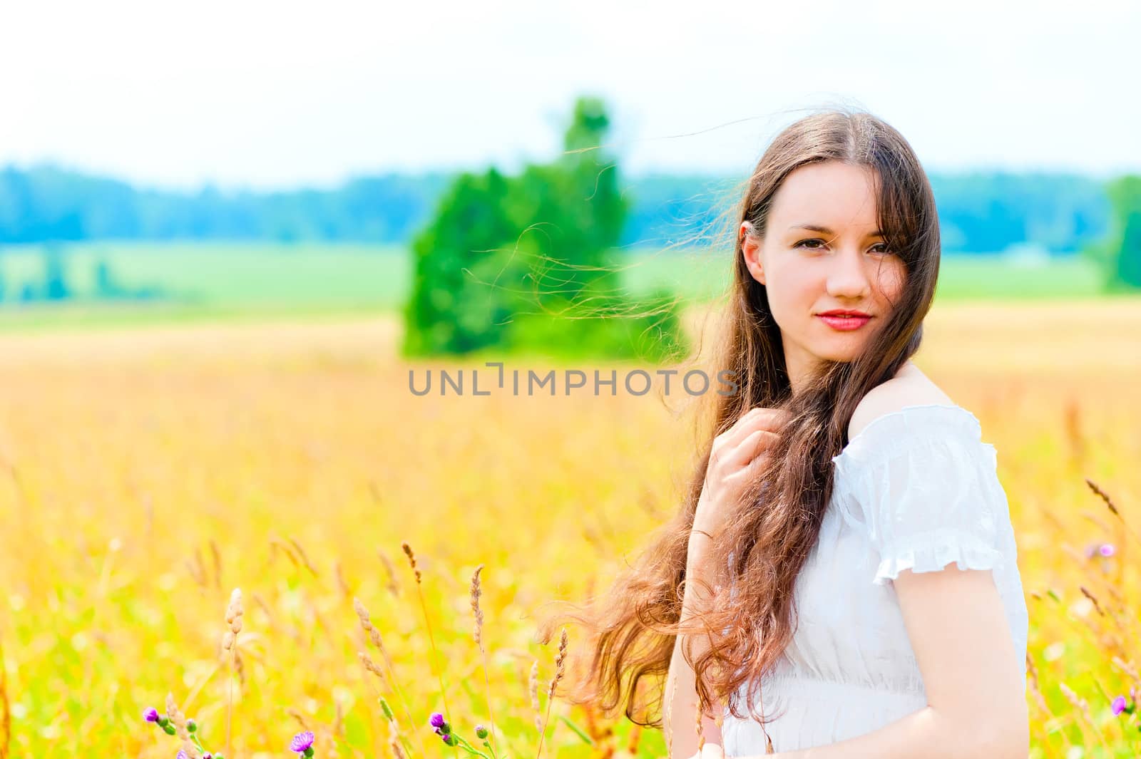 cute girl resting in a field with flowers