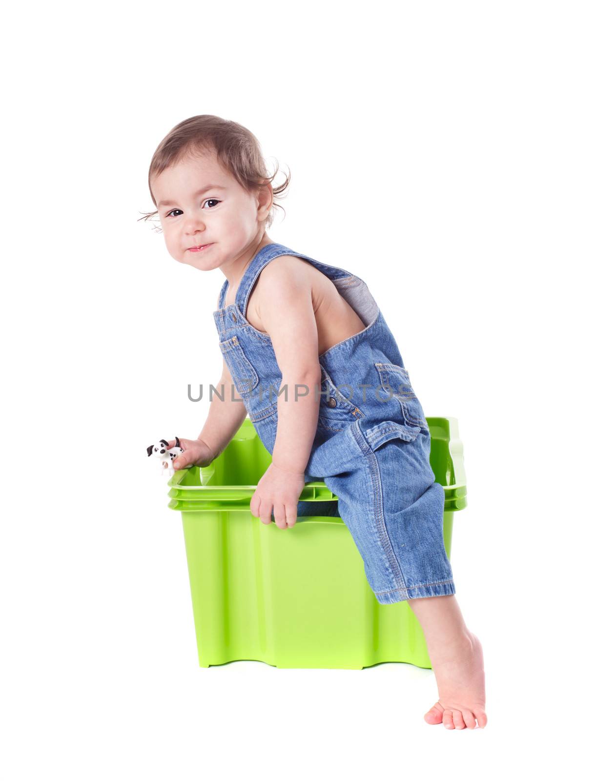 Kid plays with plastic container isolated on white