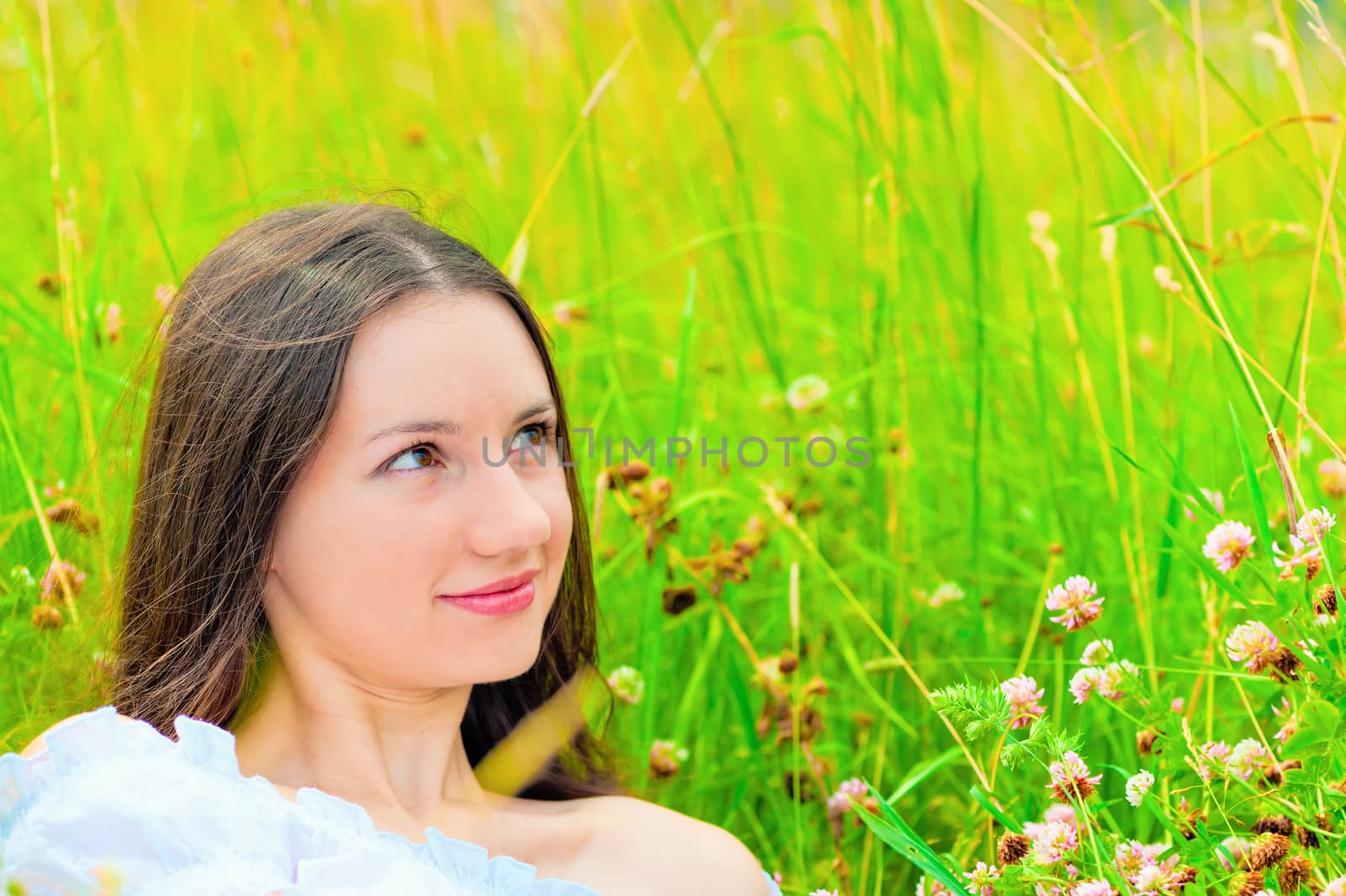 portrait of a girl in green grass and clover