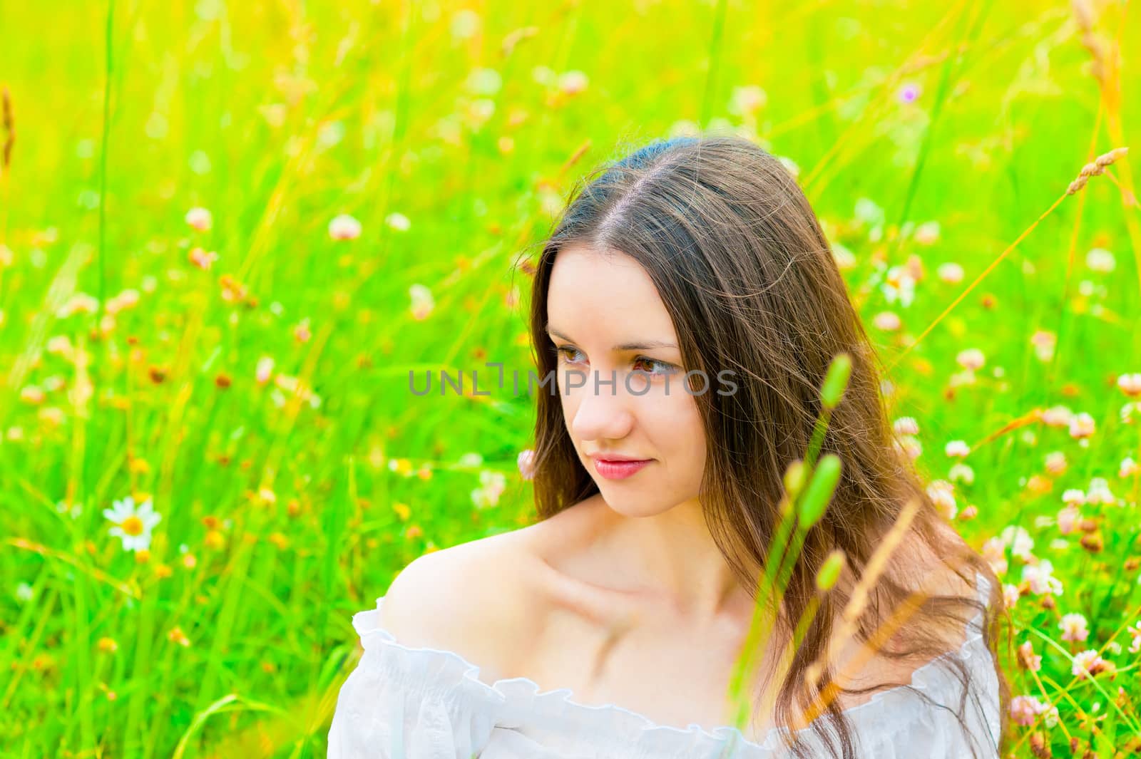 Beautiful woman relaxing in green grass