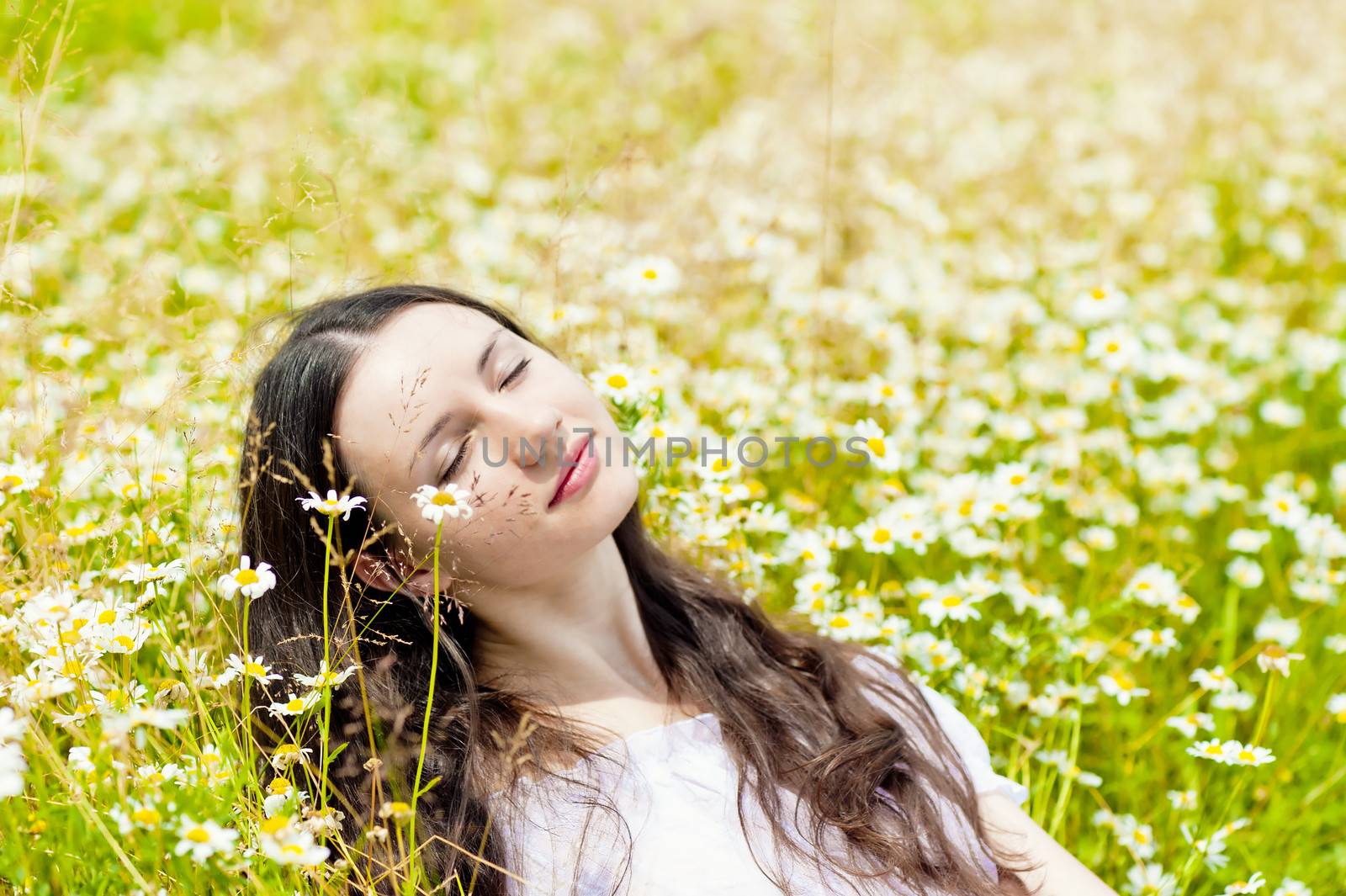 woman with closed eyes relaxes in daisies by kosmsos111