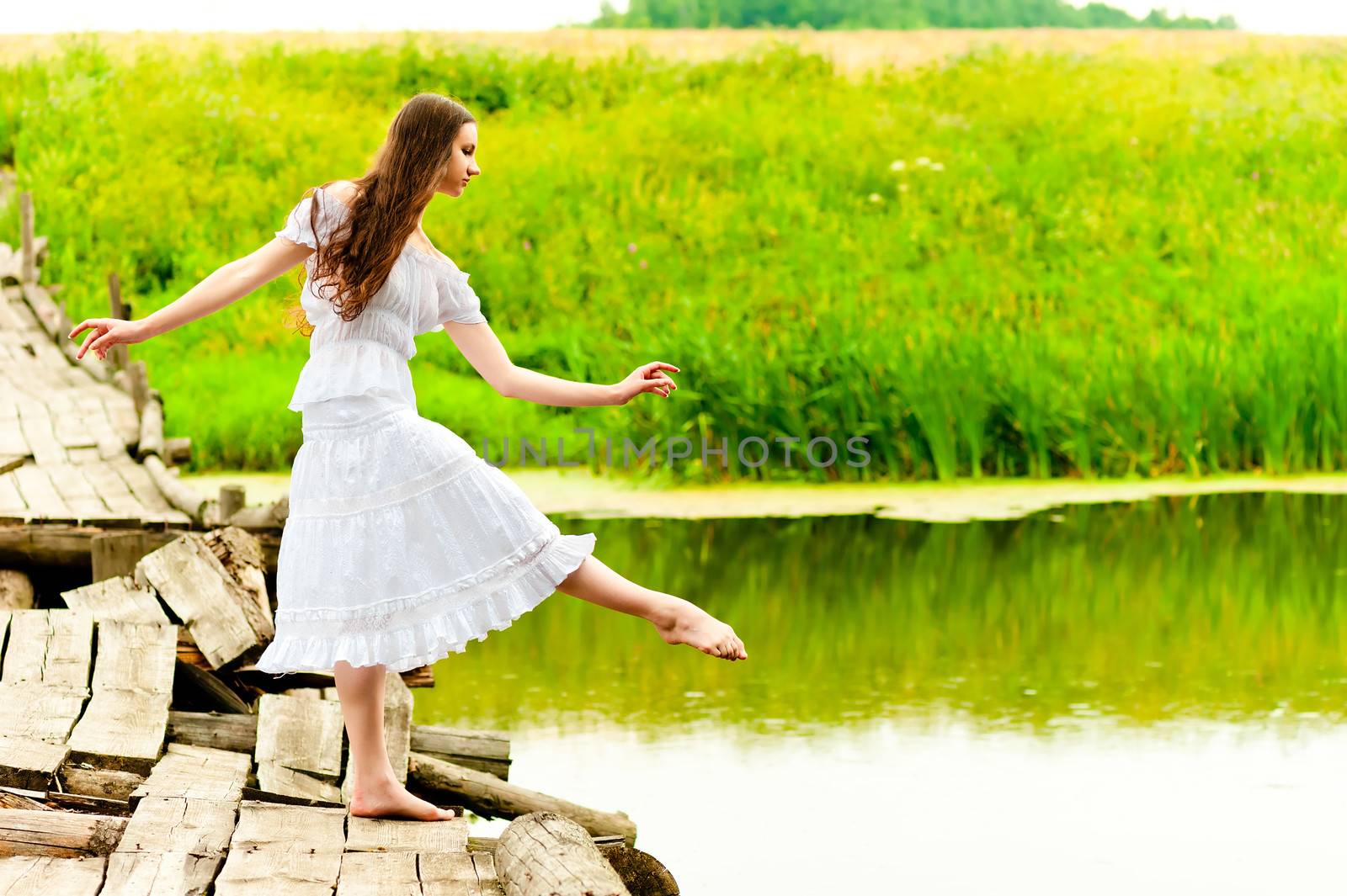 girl on the bridge balances on one leg by kosmsos111