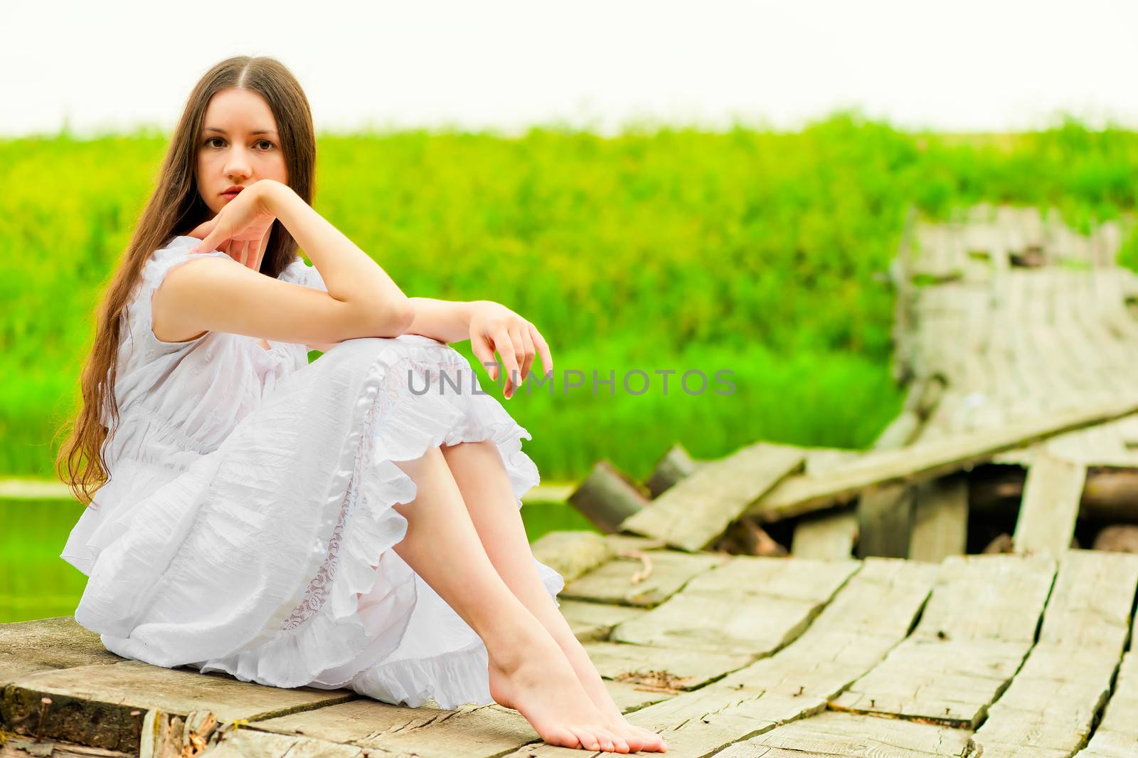 girl in a white sundress resting on the bridge by kosmsos111