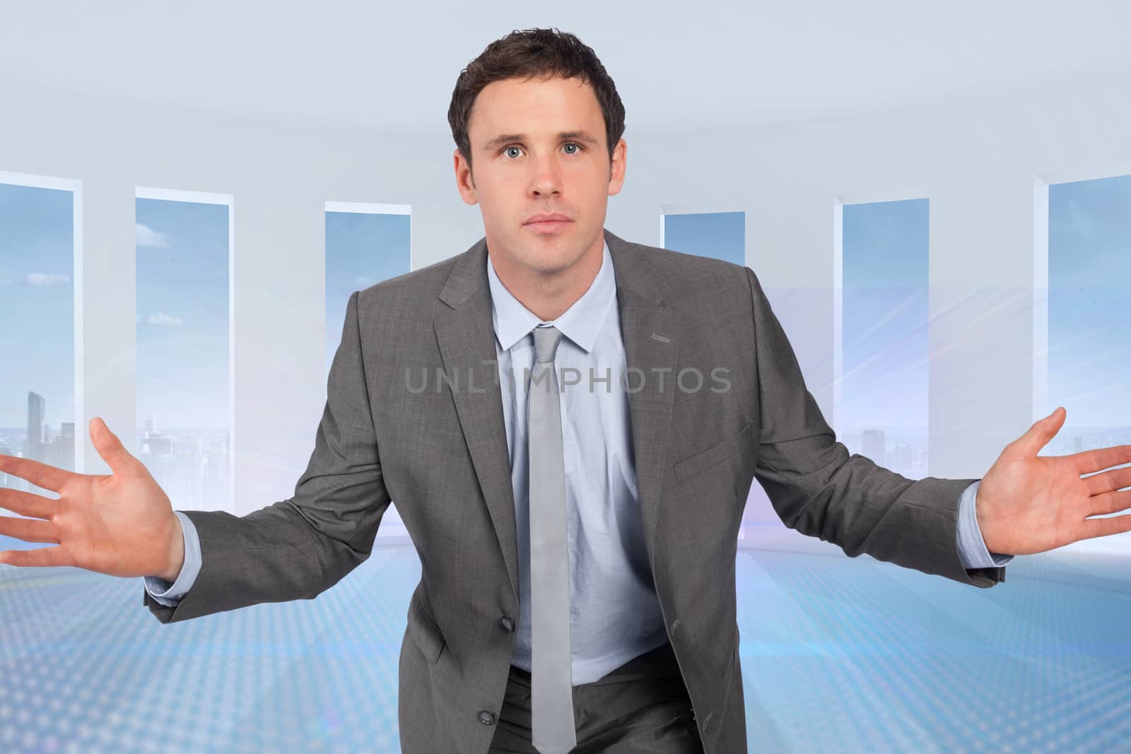 Businessman posing with hands out against abstract design in white room