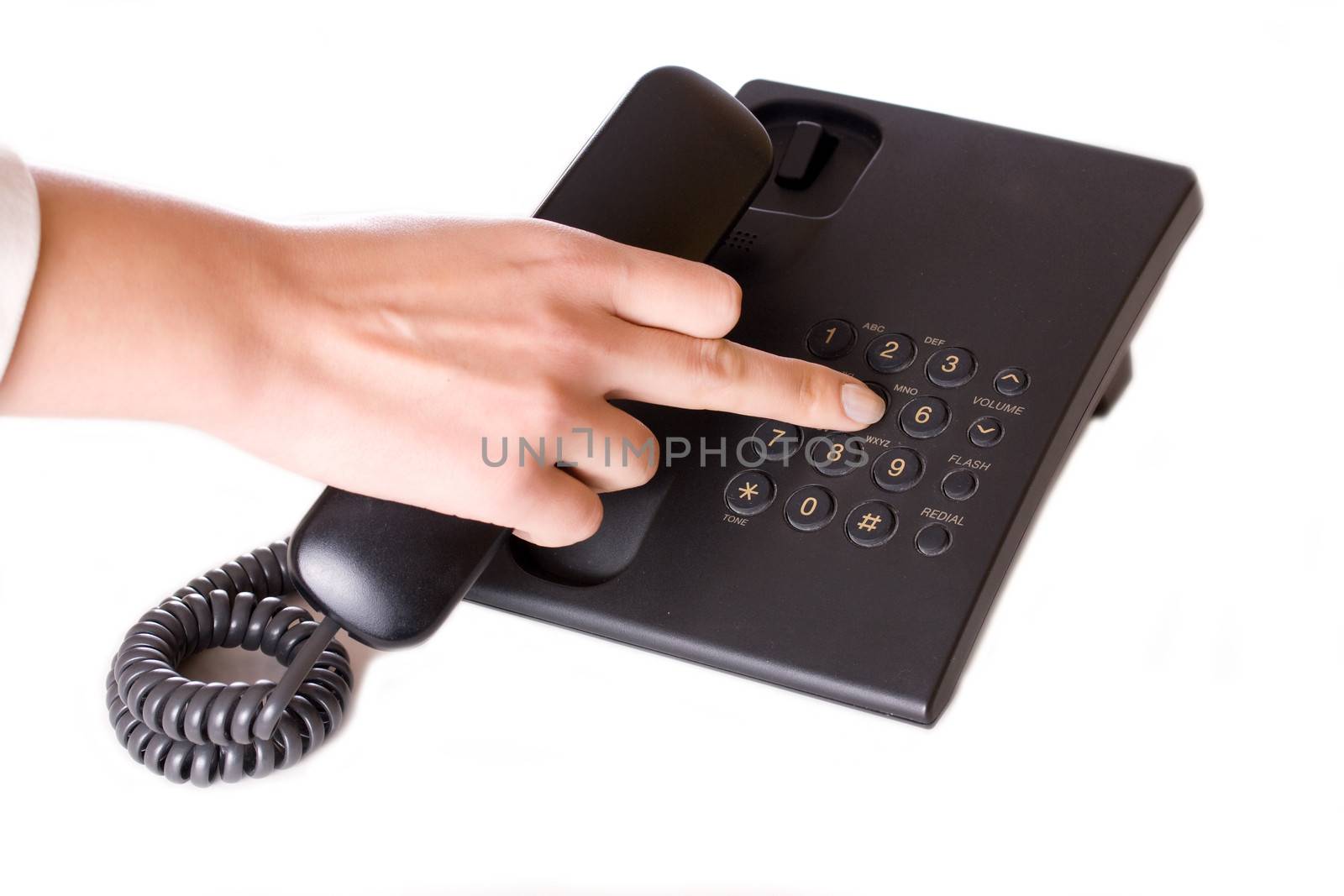 Dialing on office telephone isolated on white.