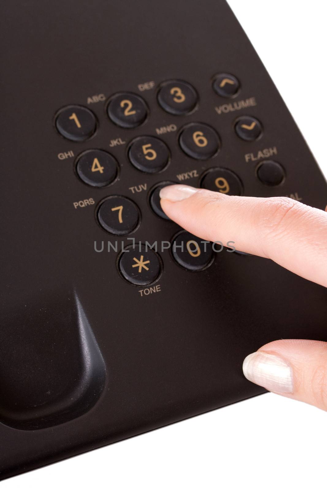 making a telephone call on a landline holding the handset close and calling in the number on the keypad with the other hand.