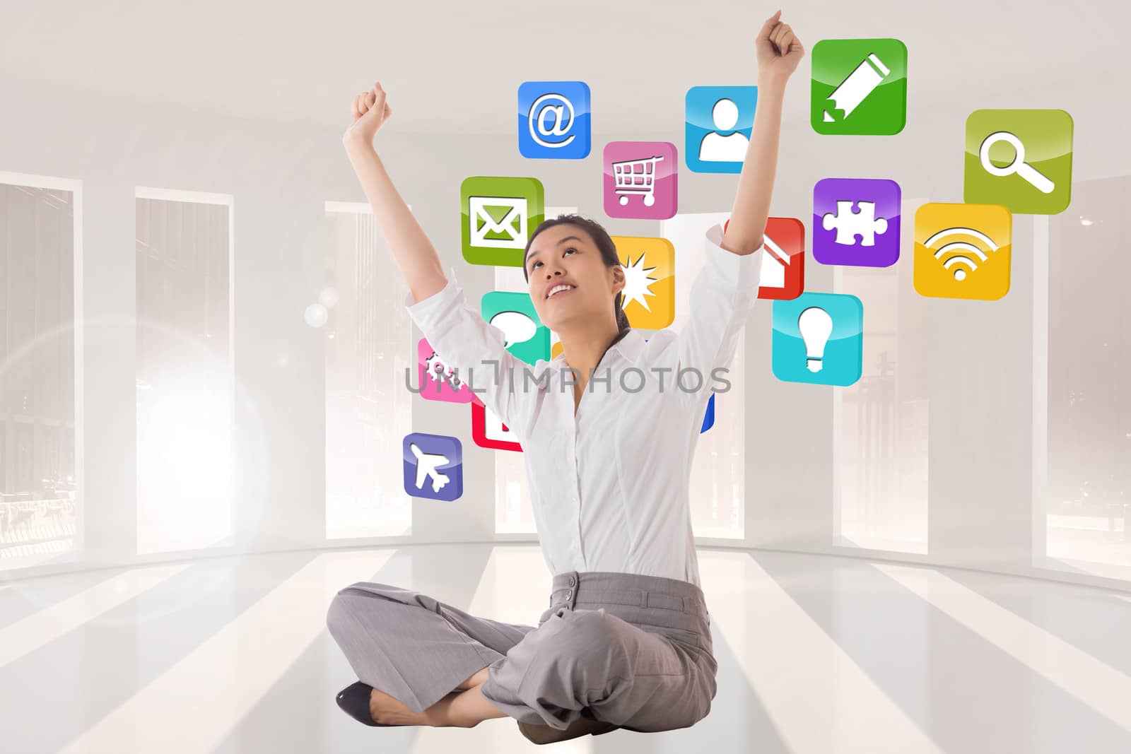 Composite image of businesswoman sitting cross legged cheering by Wavebreakmedia