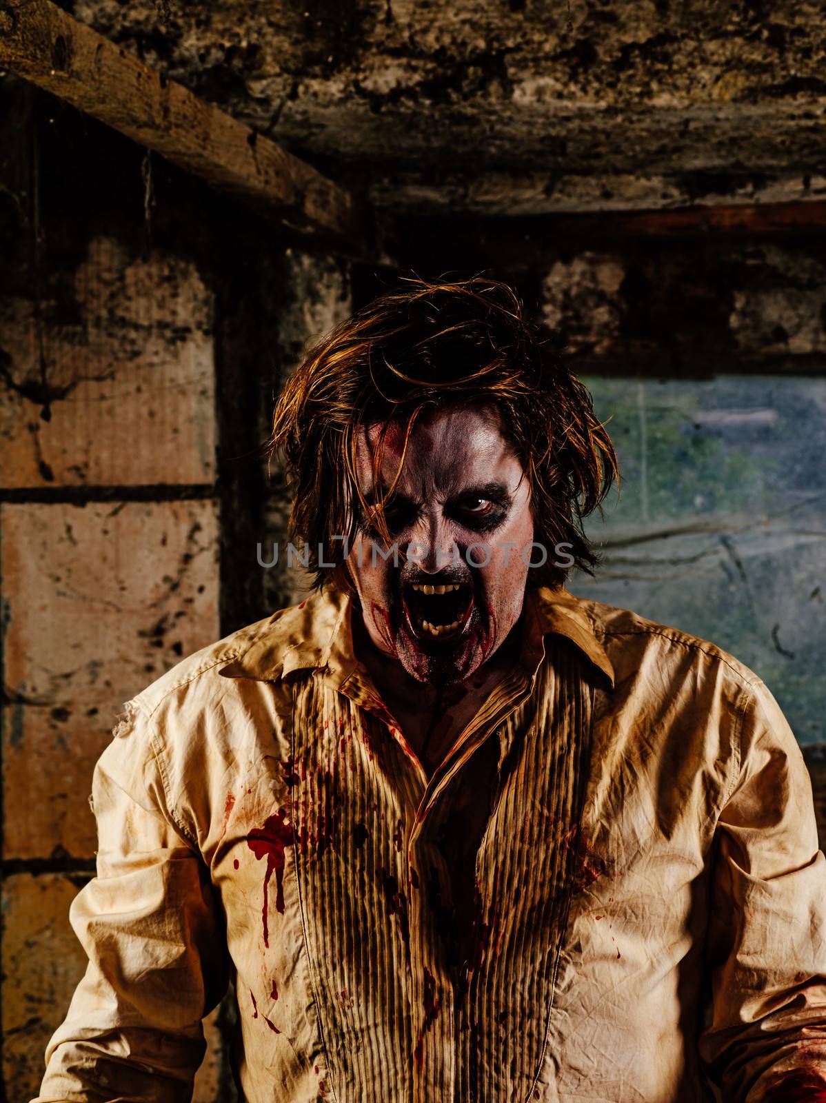 Photo of a hungry zombie covered with blood about to attack you.
