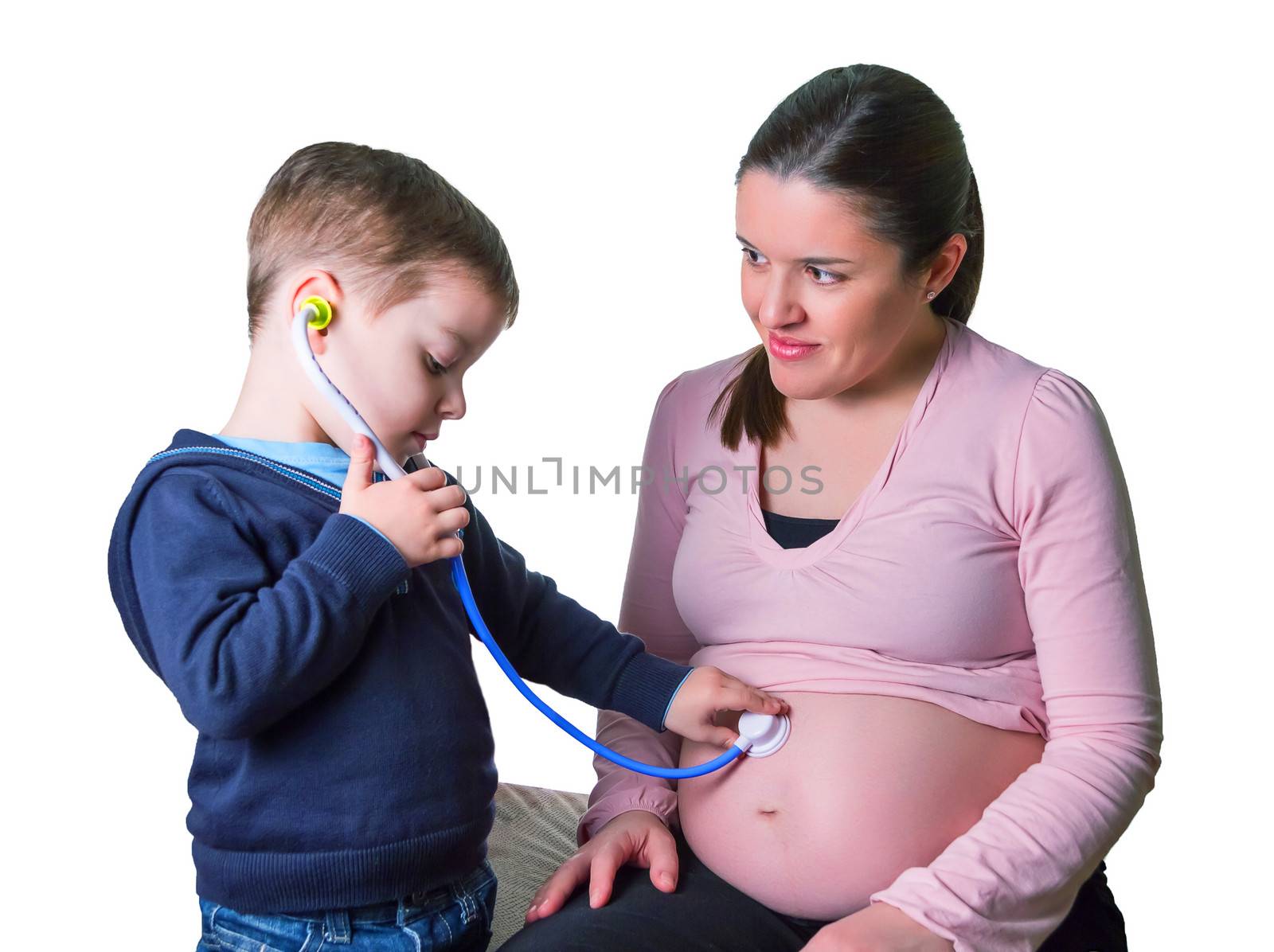 Funny child doctor examining his pregnant mother with medical toys