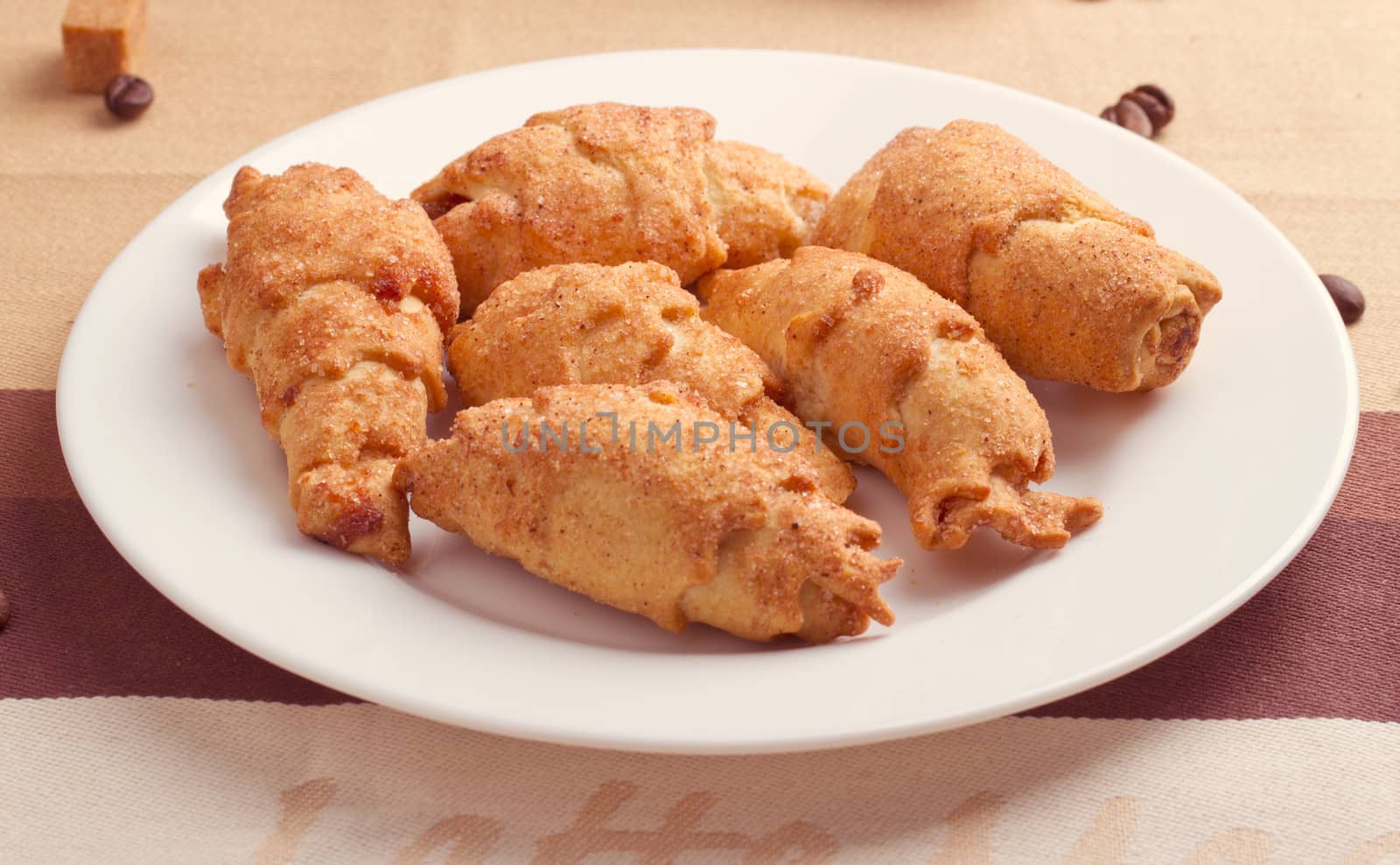 Crispy fresh croissants in a basket on a wooden table