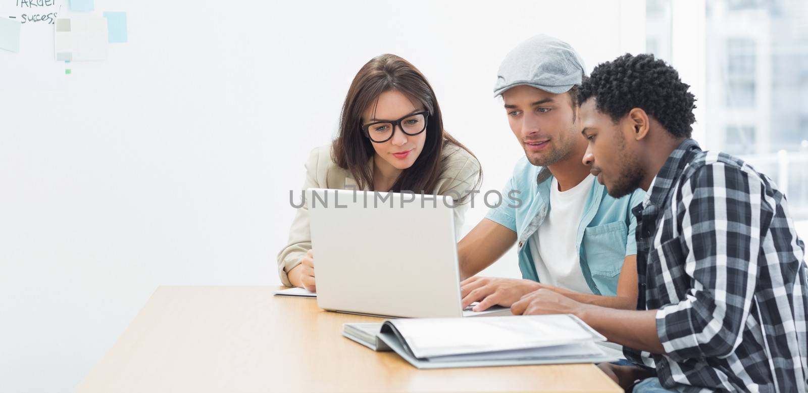 Artists working at desk in creative office by Wavebreakmedia