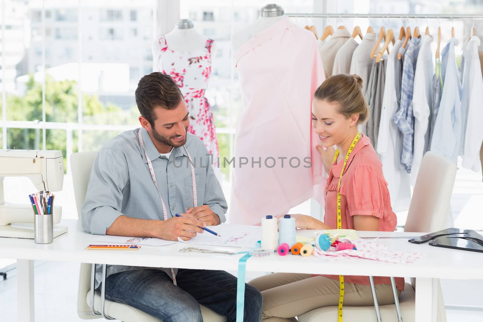 Fashion designers at work in bright studio by Wavebreakmedia