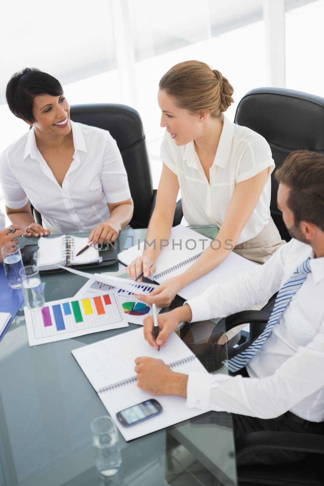 Young well dressed business people in discussion at a bright office