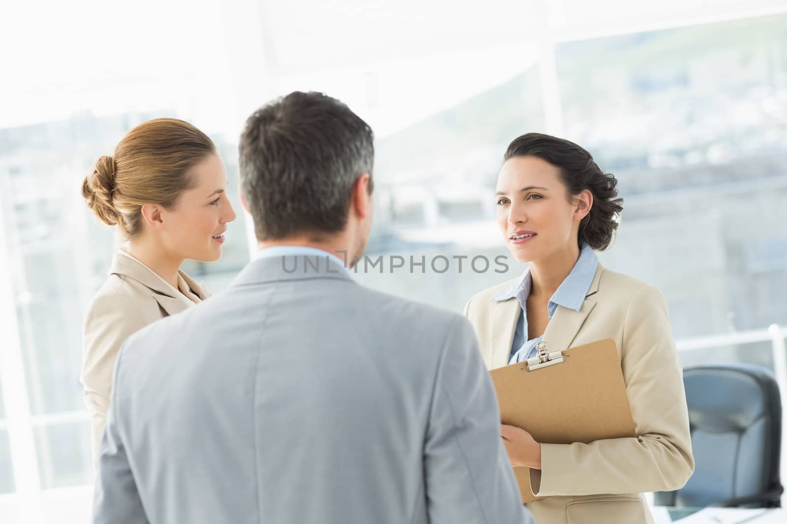 Business colleagues in discussion at office by Wavebreakmedia