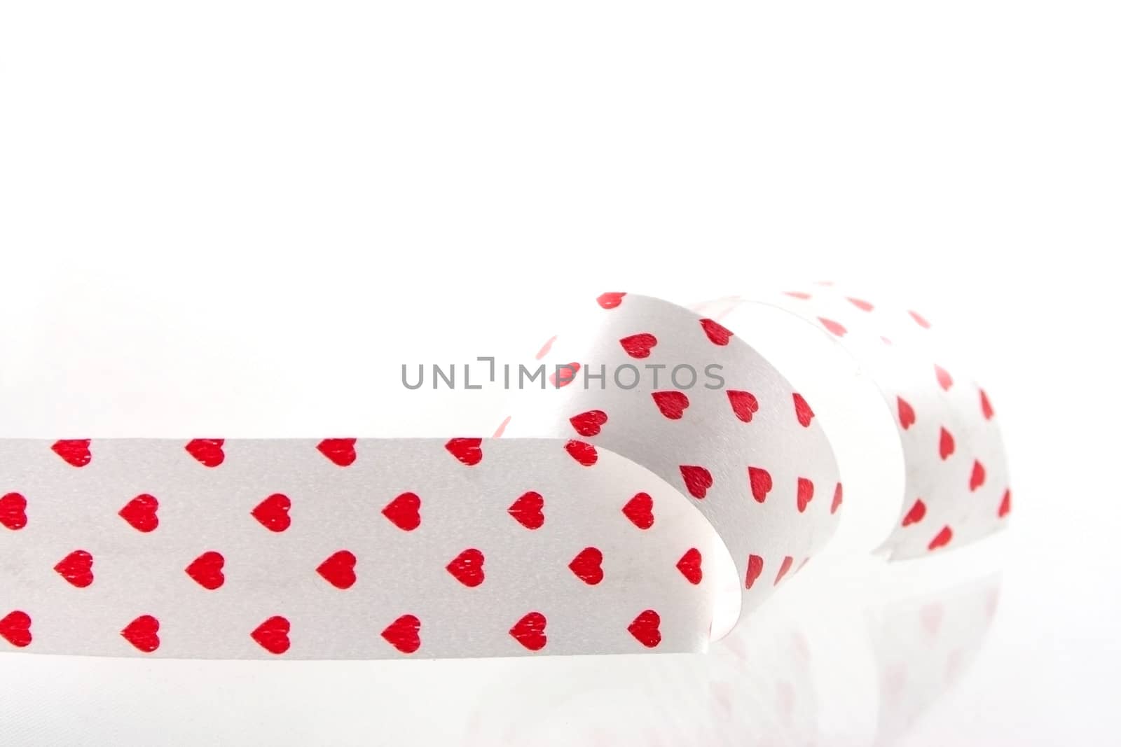Studio shot of tape with red hearts
