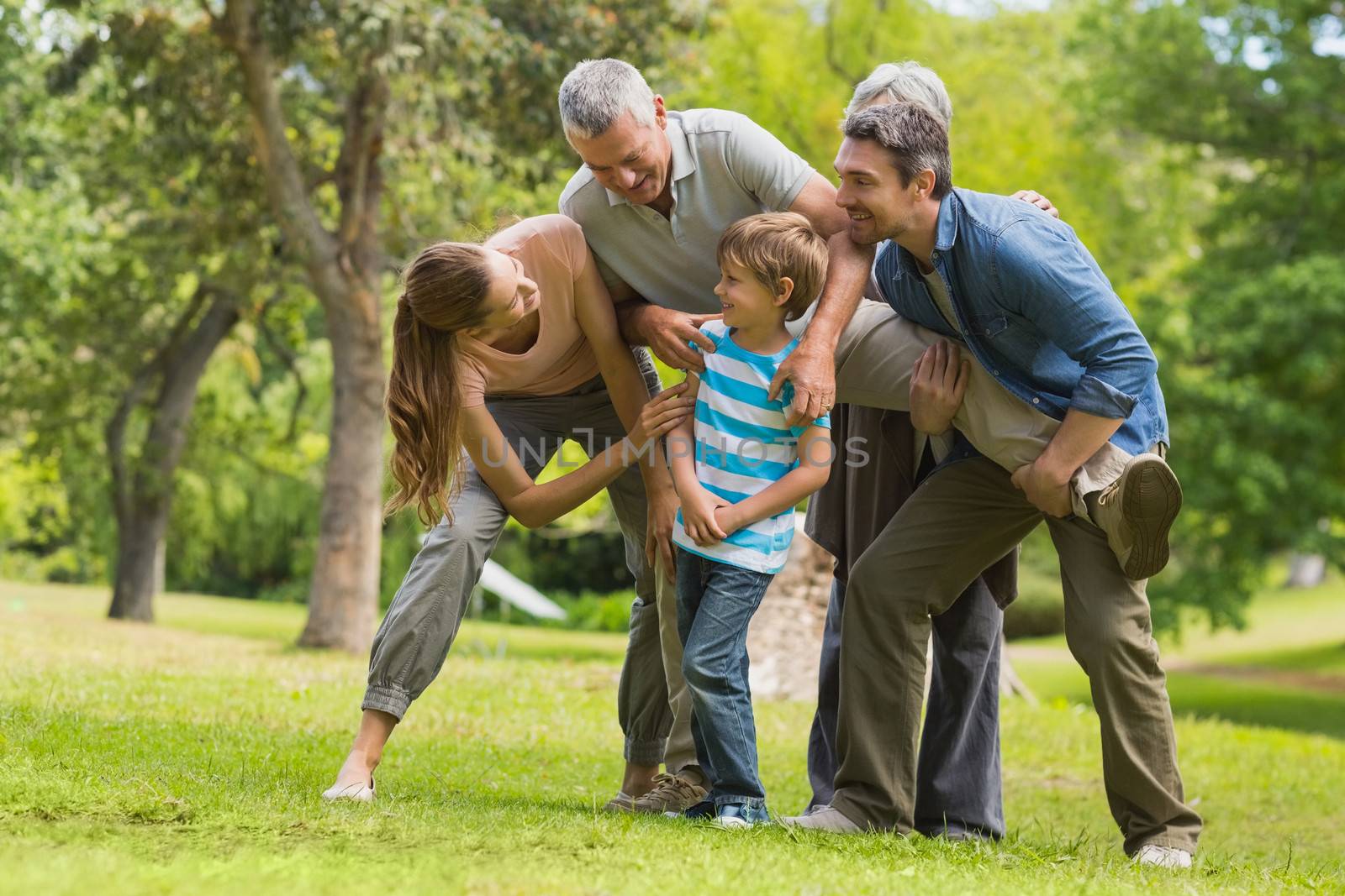 Cheerful family playing in the park