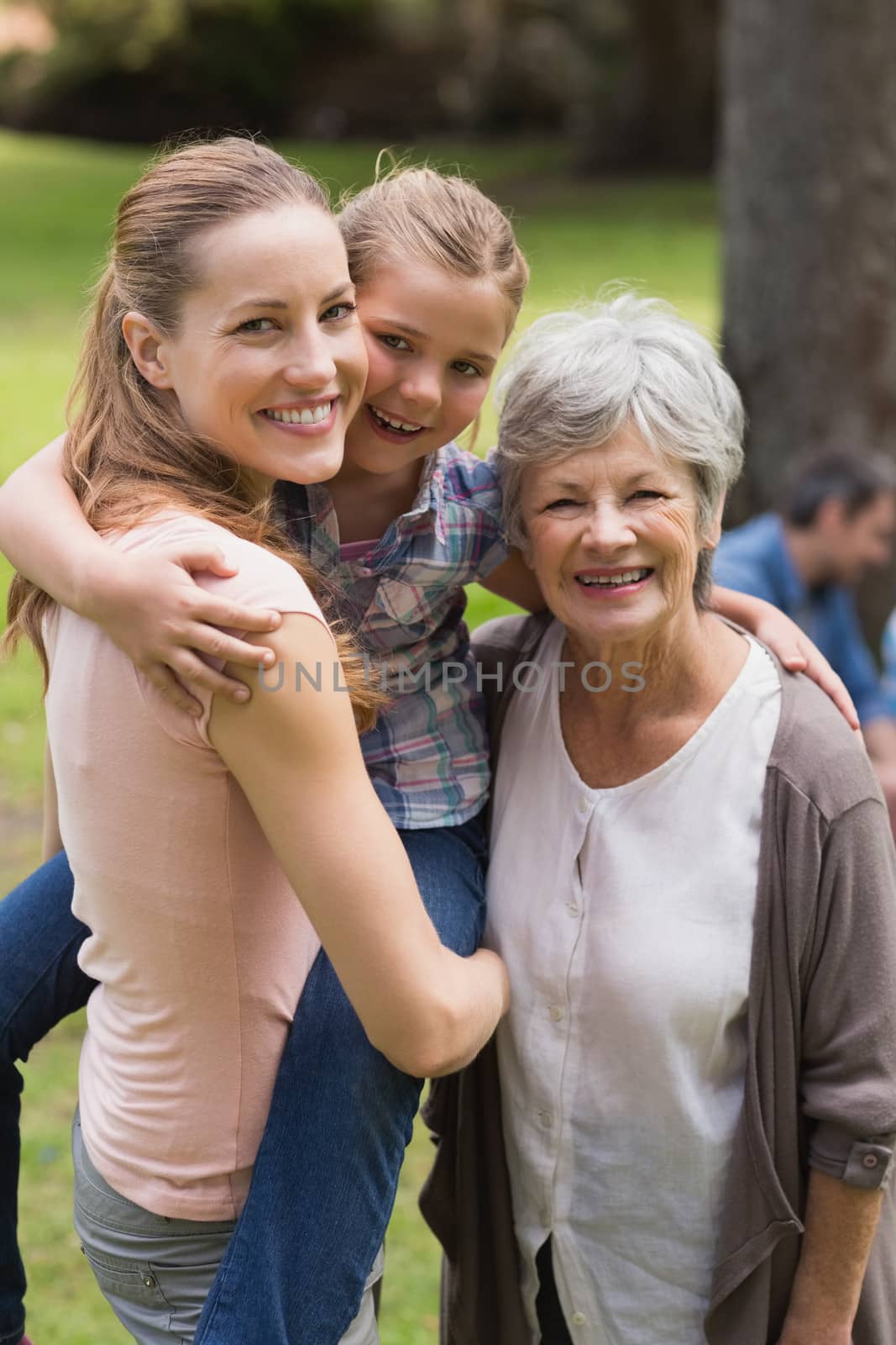 Portrait of grandmother mother and daughter at park by Wavebreakmedia