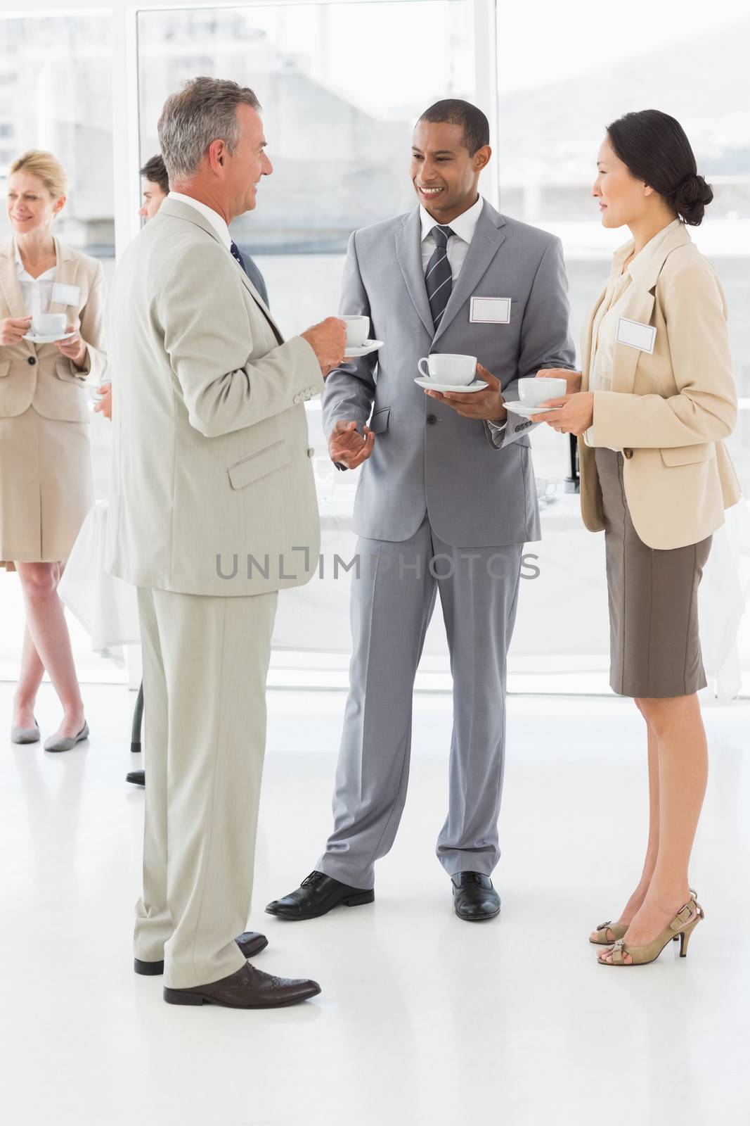 Business people talking and drinking coffee at a conference in the office