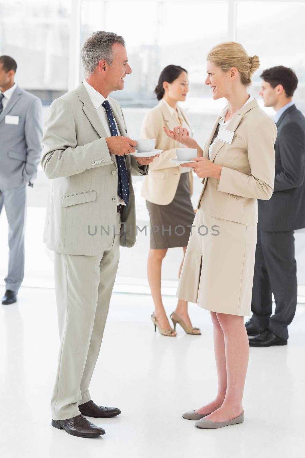 Business people chatting and having coffee at a conference by Wavebreakmedia