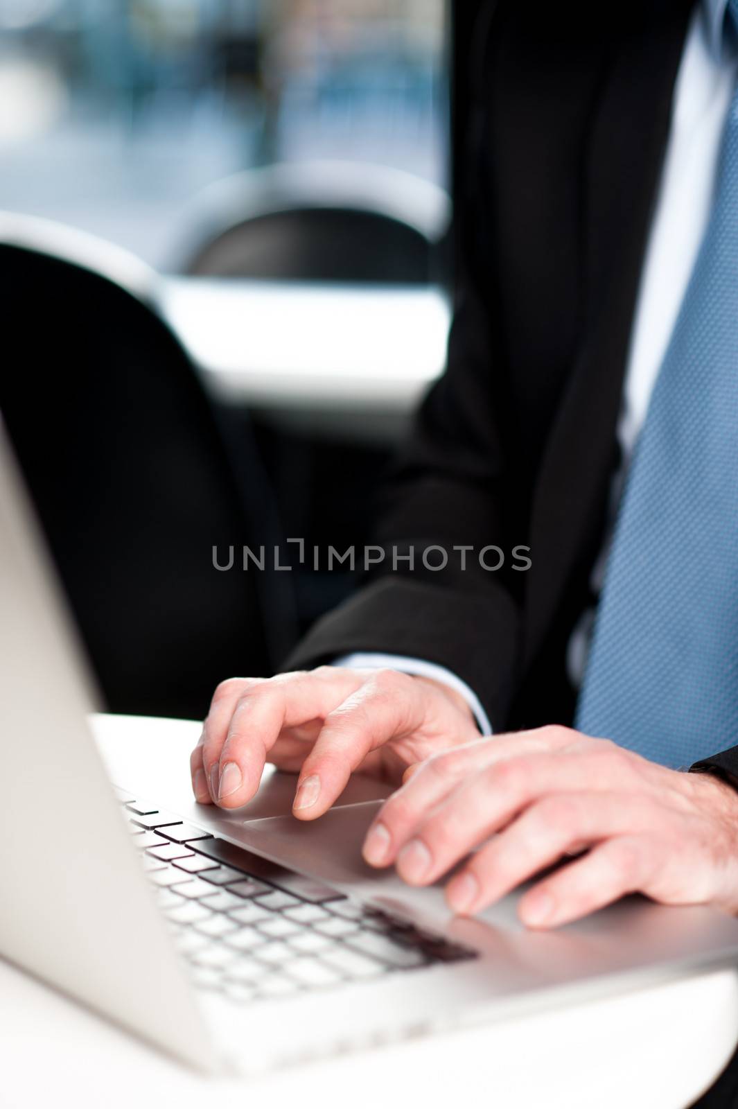 Guy working on laptop, cropped image