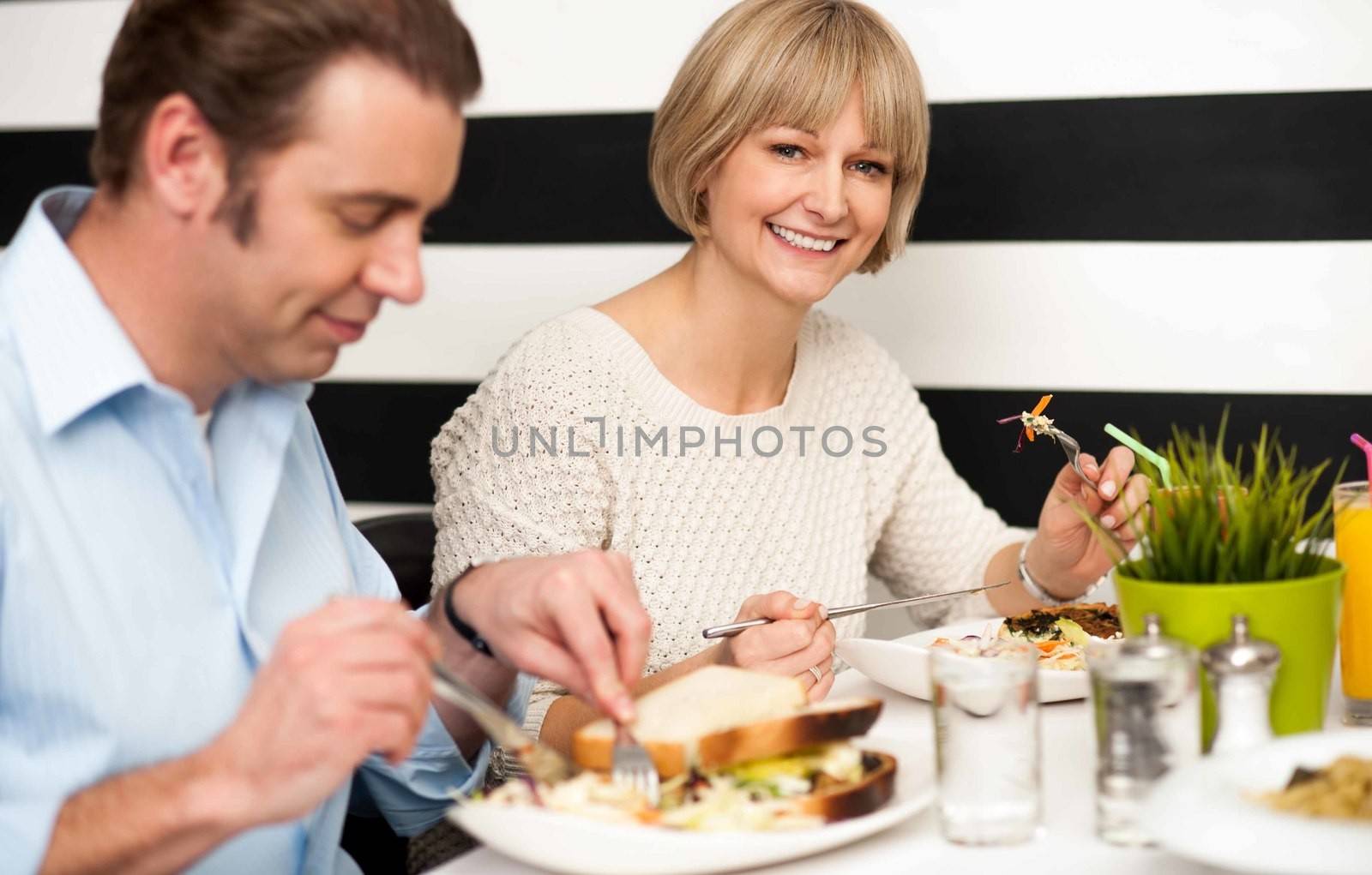 Couple enjoying delicious breakfast by stockyimages