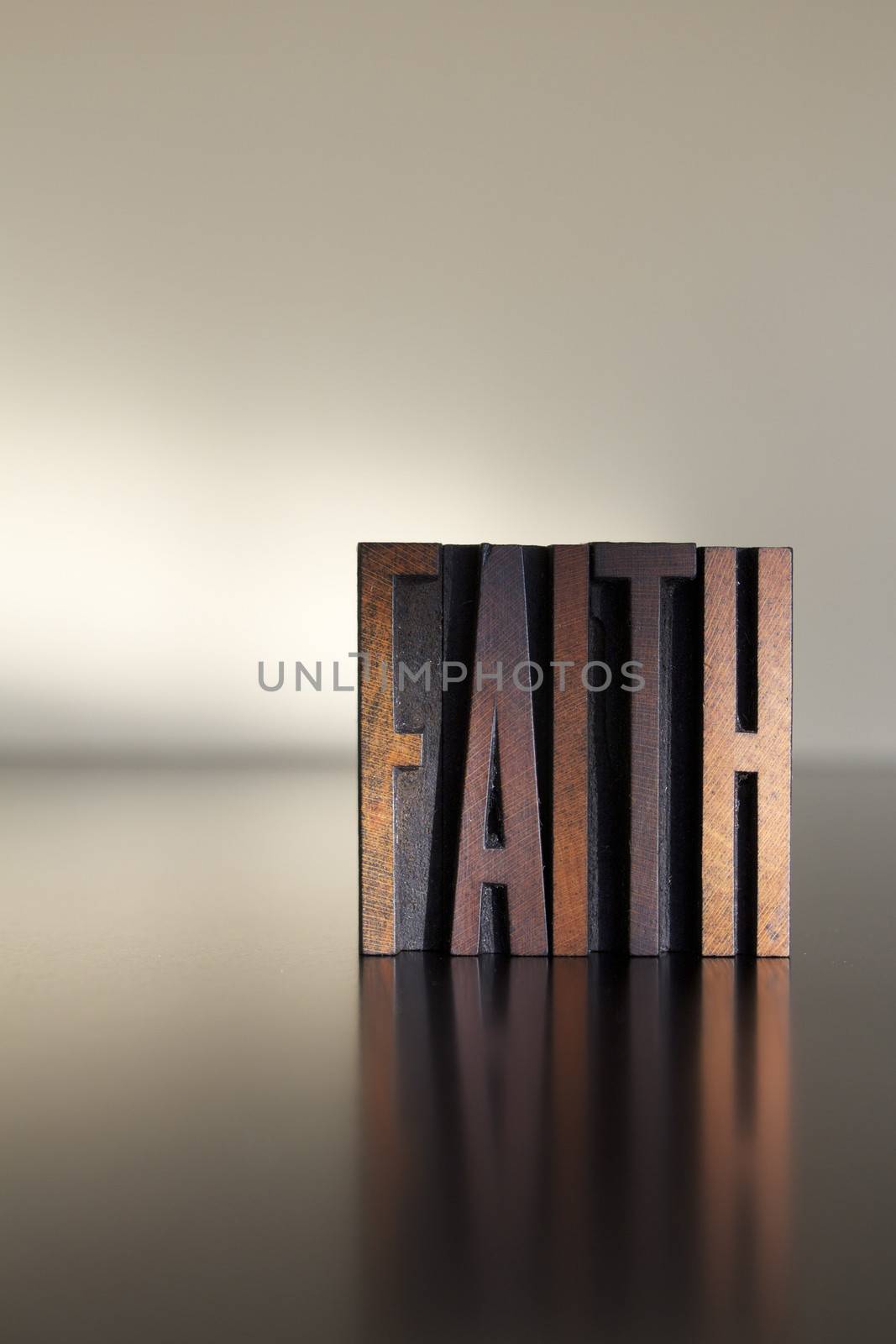 The word FAITH written in vintage letterpress type