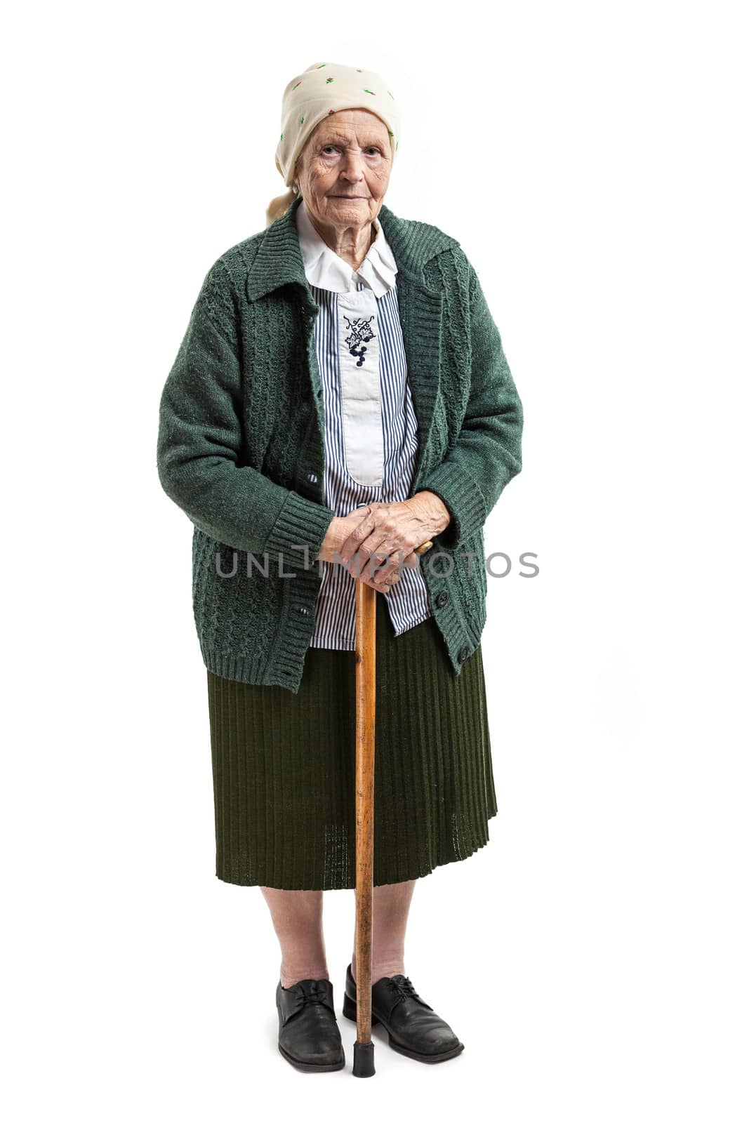 Old woman with a cane over white background by photobac