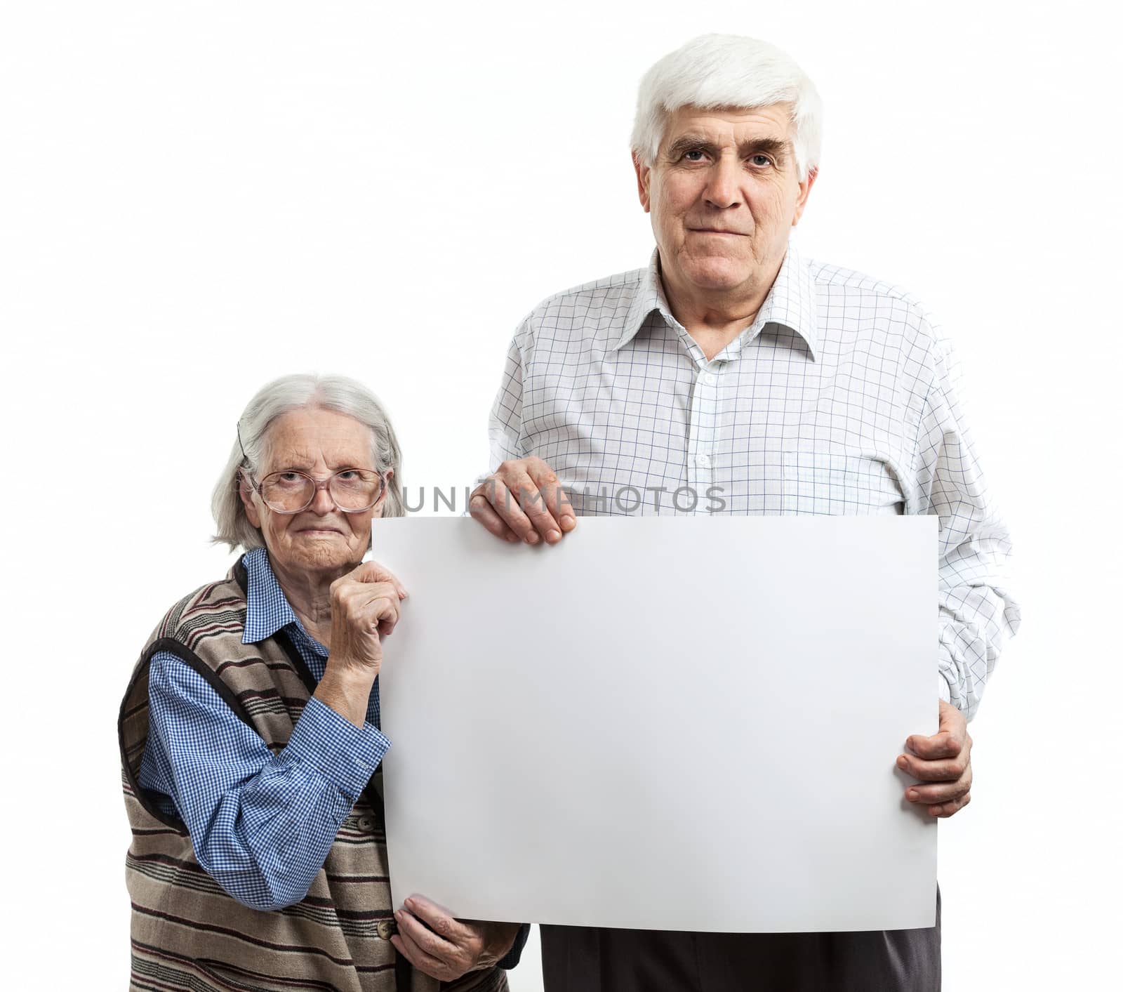 Senior woman and mature man holding a blank billboard