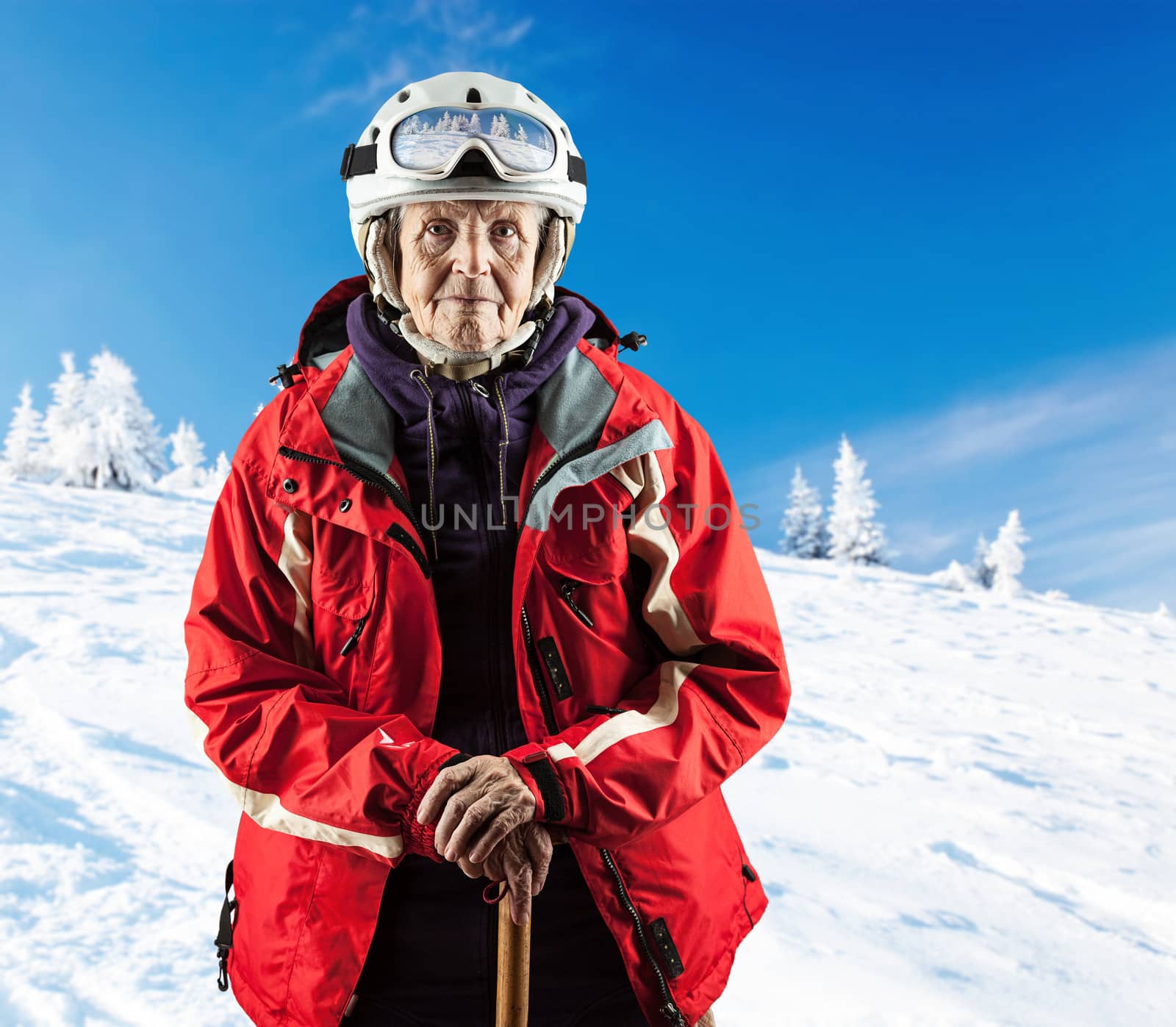 Senior woman wearing ski jacket on snowy slope by photobac