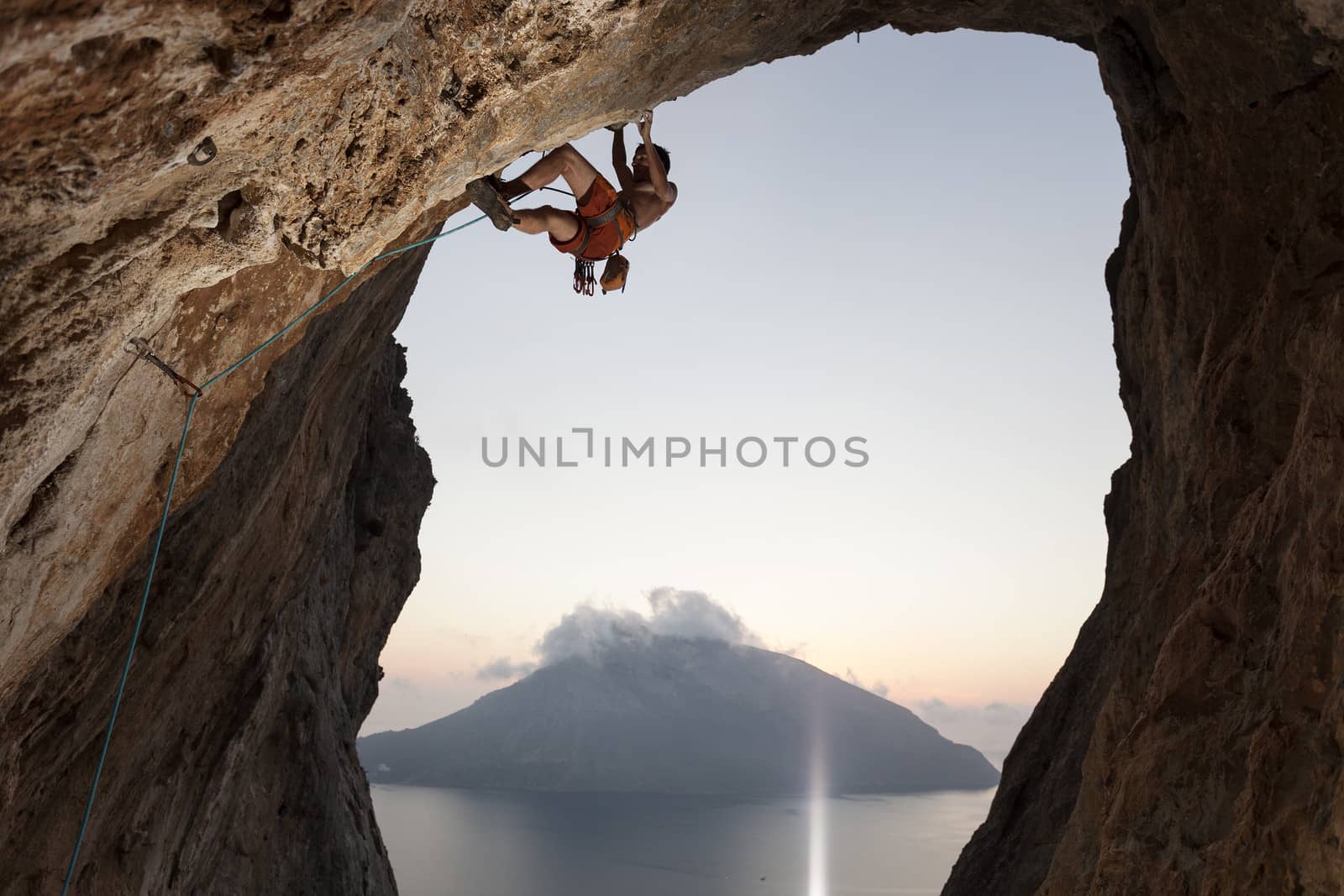 Rock climber on cliff. Kalymnos Island, Greece. by photobac