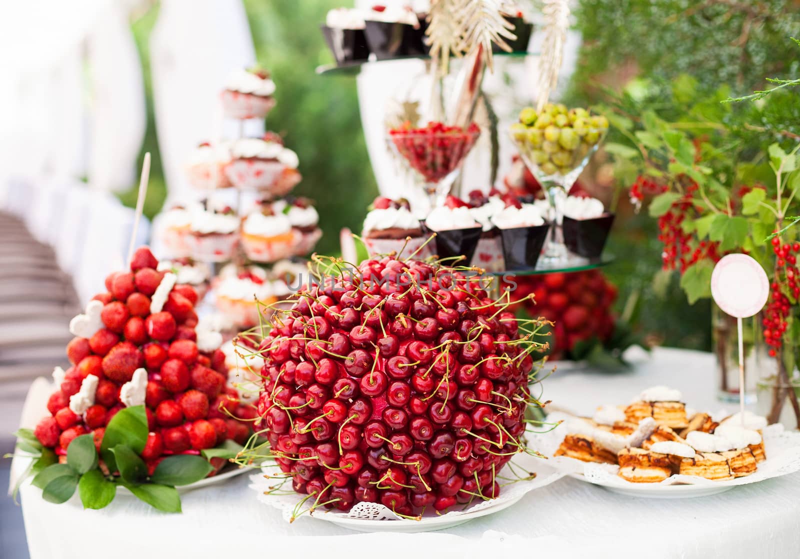 Sweet bar with berries and cakes by photobac