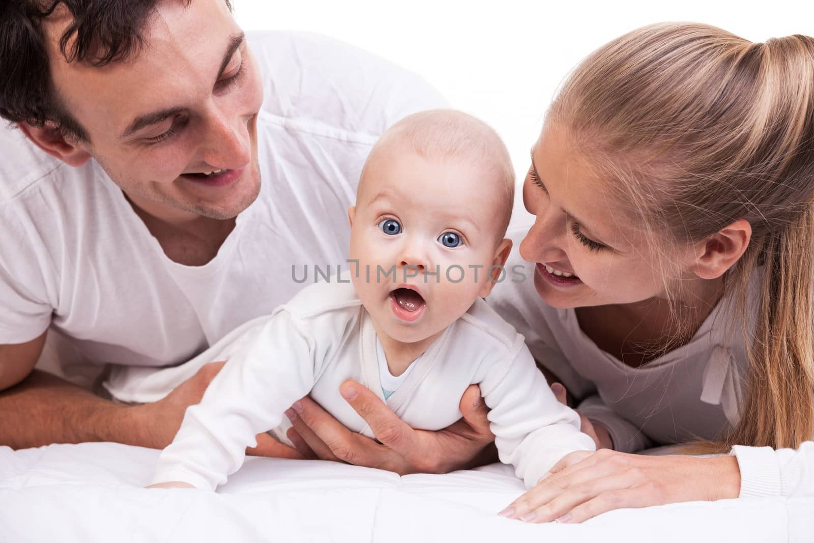 Closeup of young family with baby boy over white by photobac