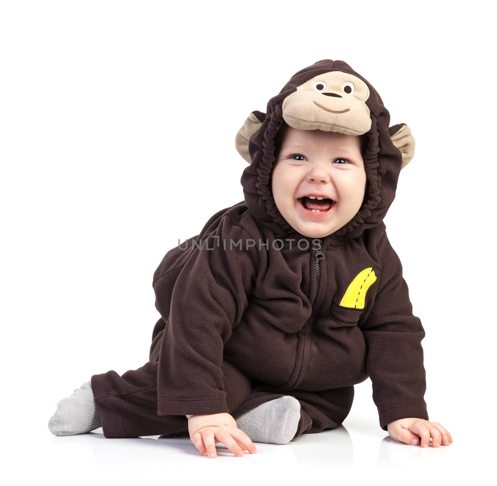 Baby boy dressed in monkey costume over white background