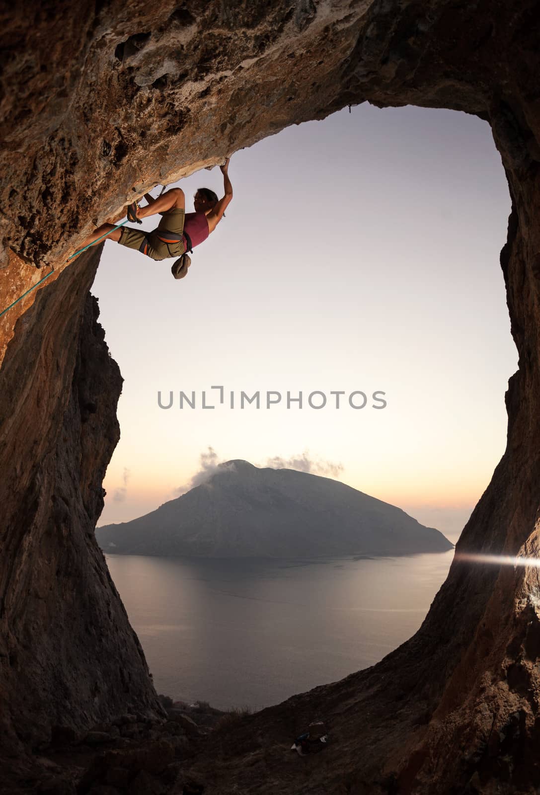 Female rock climber at sunset, Kalymnos, Greece by photobac