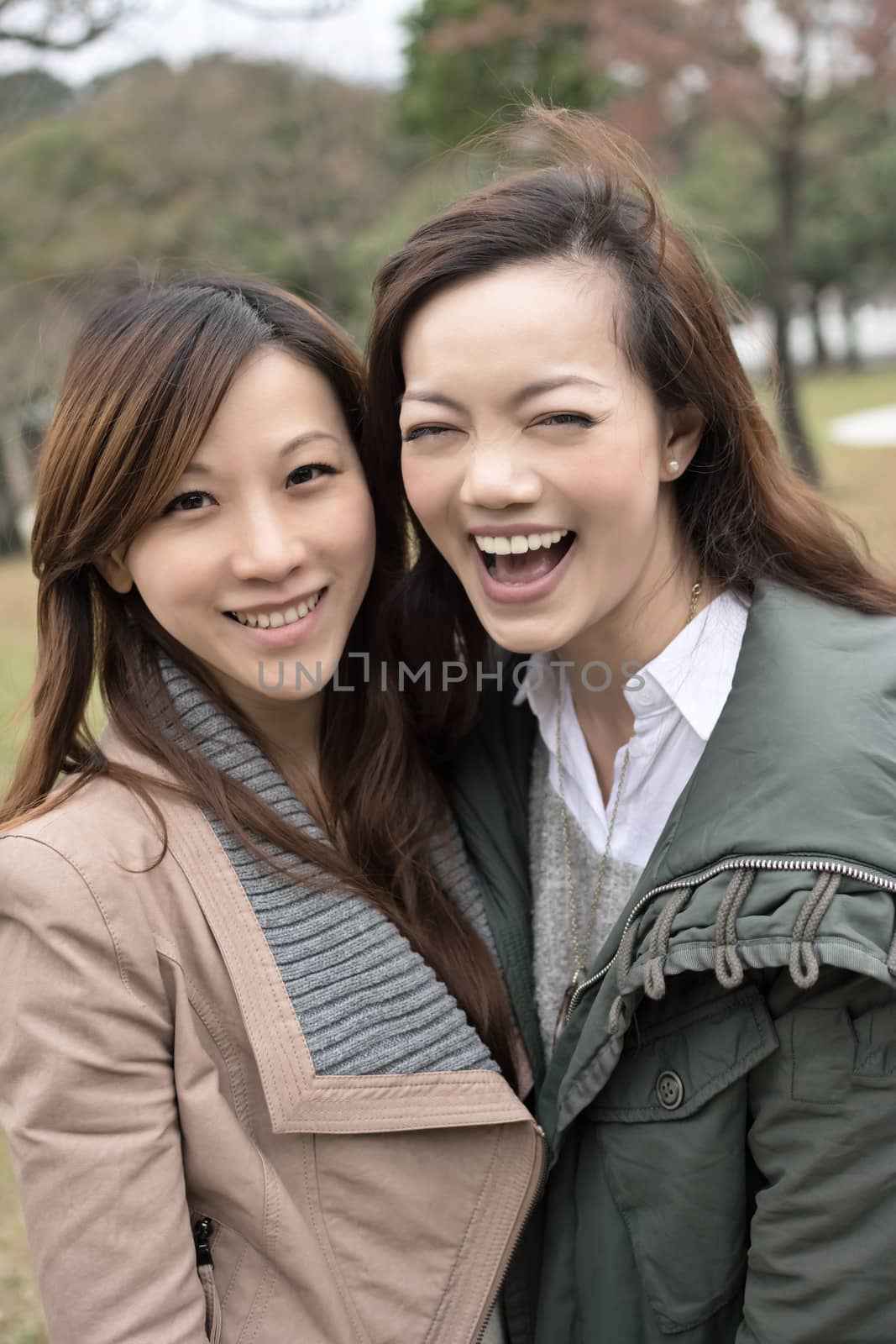 Happy smiling Asian women in the park by elwynn