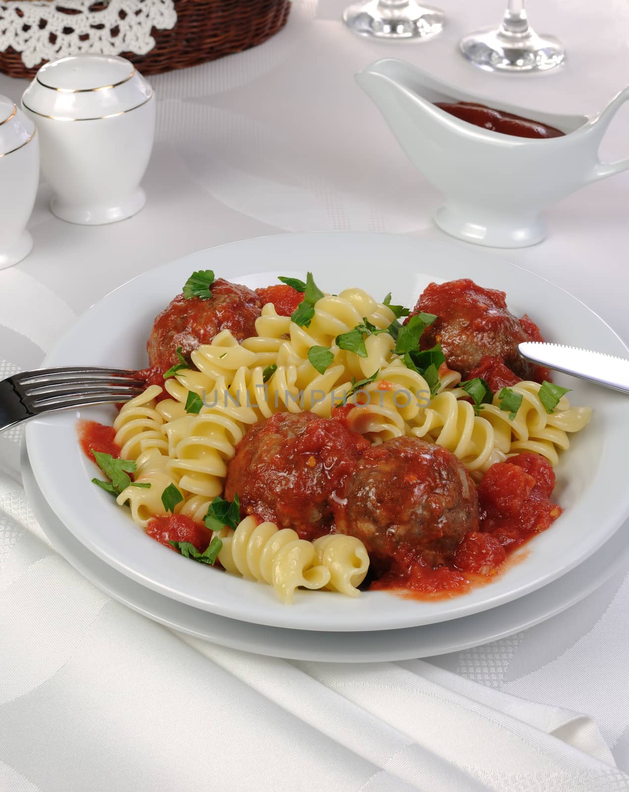 Pasta with meatballs in tomato sauce and herbs