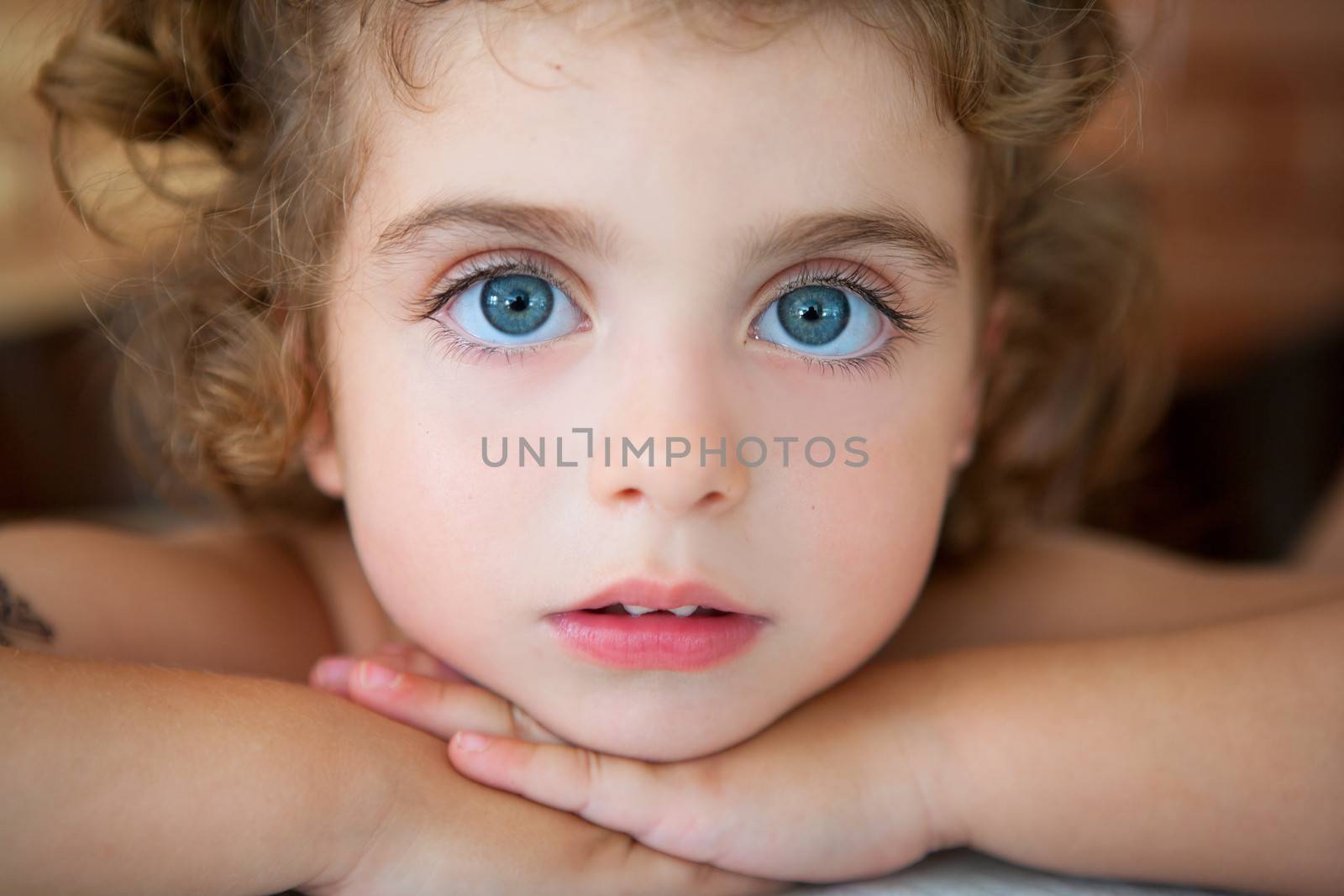 big blue eyes toddler girl looking at camera by lunamarina
