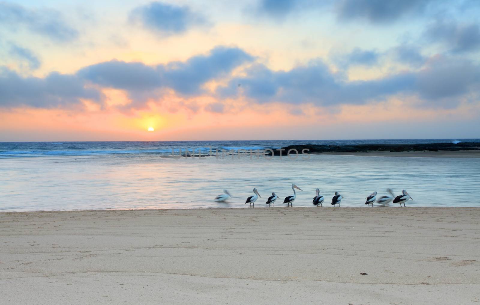 The sun rises up at the horizon at The Entrance North, on a beautiful summer day in Australia