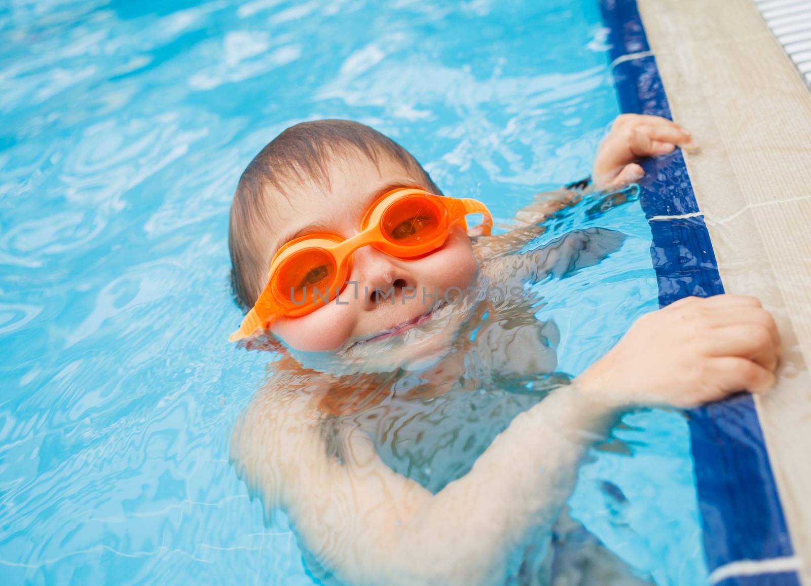 Activities on the pool. Cute boy in swimming pool