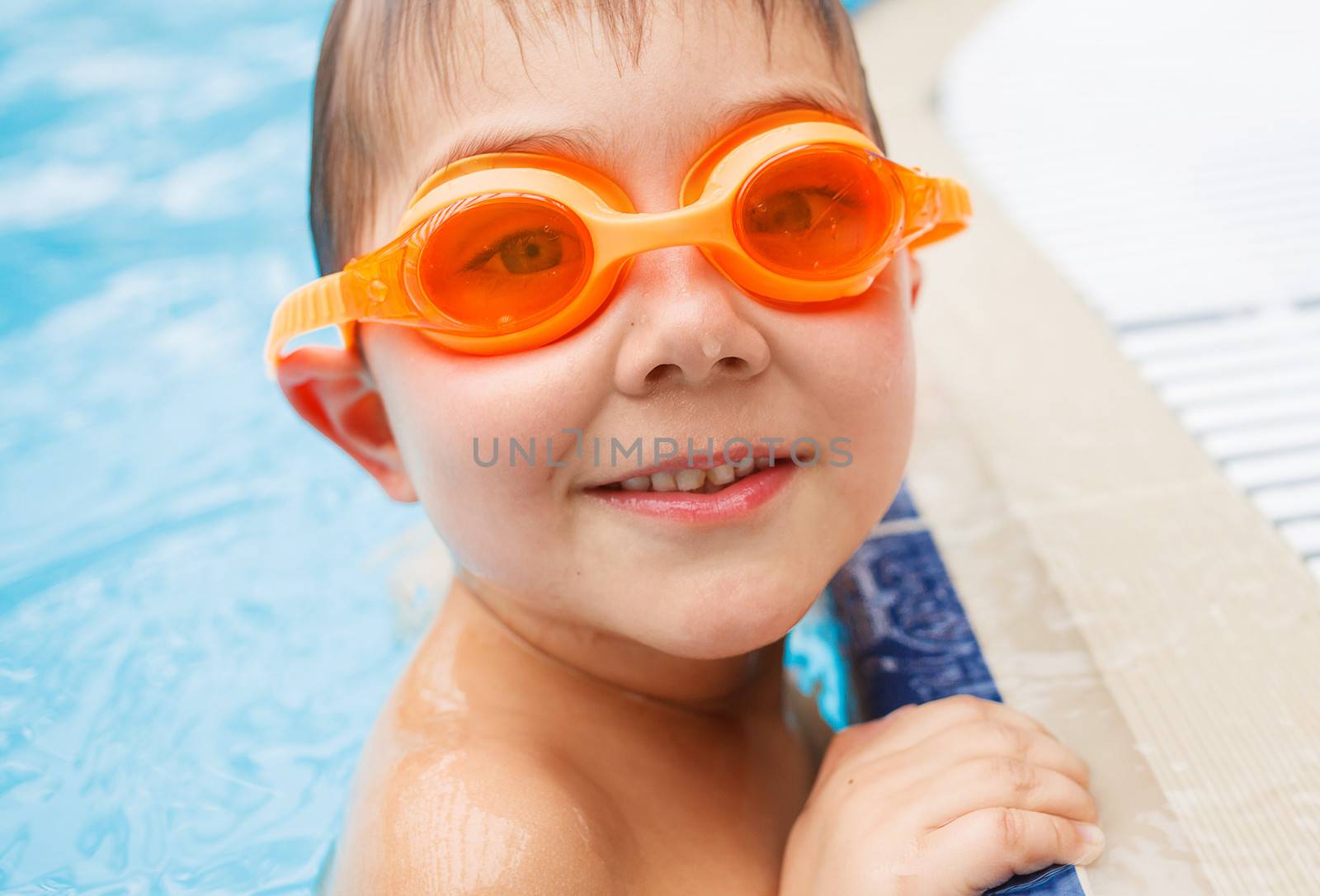 Activities on the pool. Cute boy in swimming pool