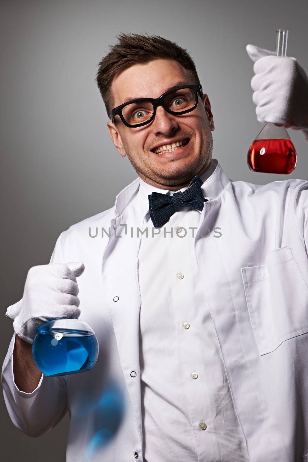Crazy scientist against grey background