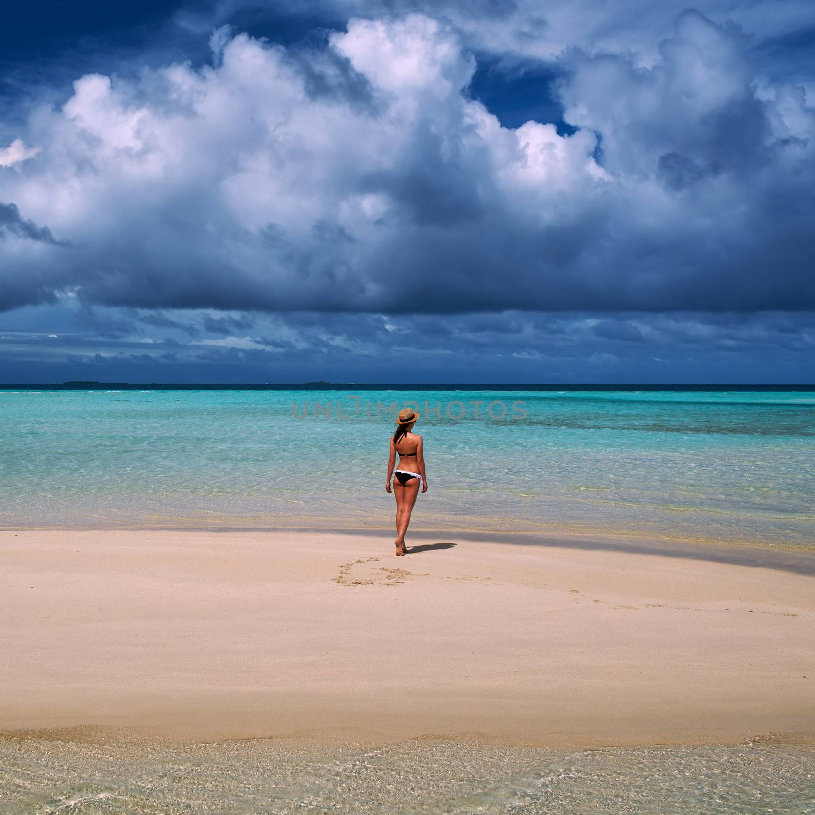 Woman in bikini at tropical beach