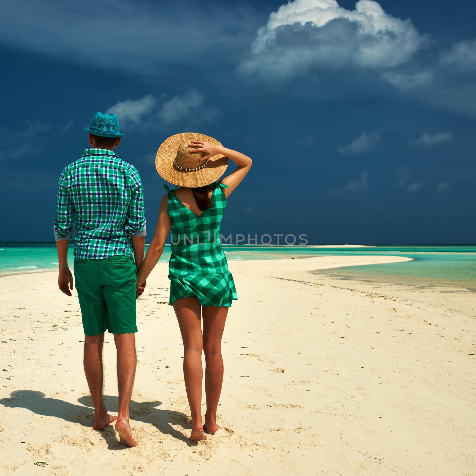 Couple in green on a tropical beach at Maldives