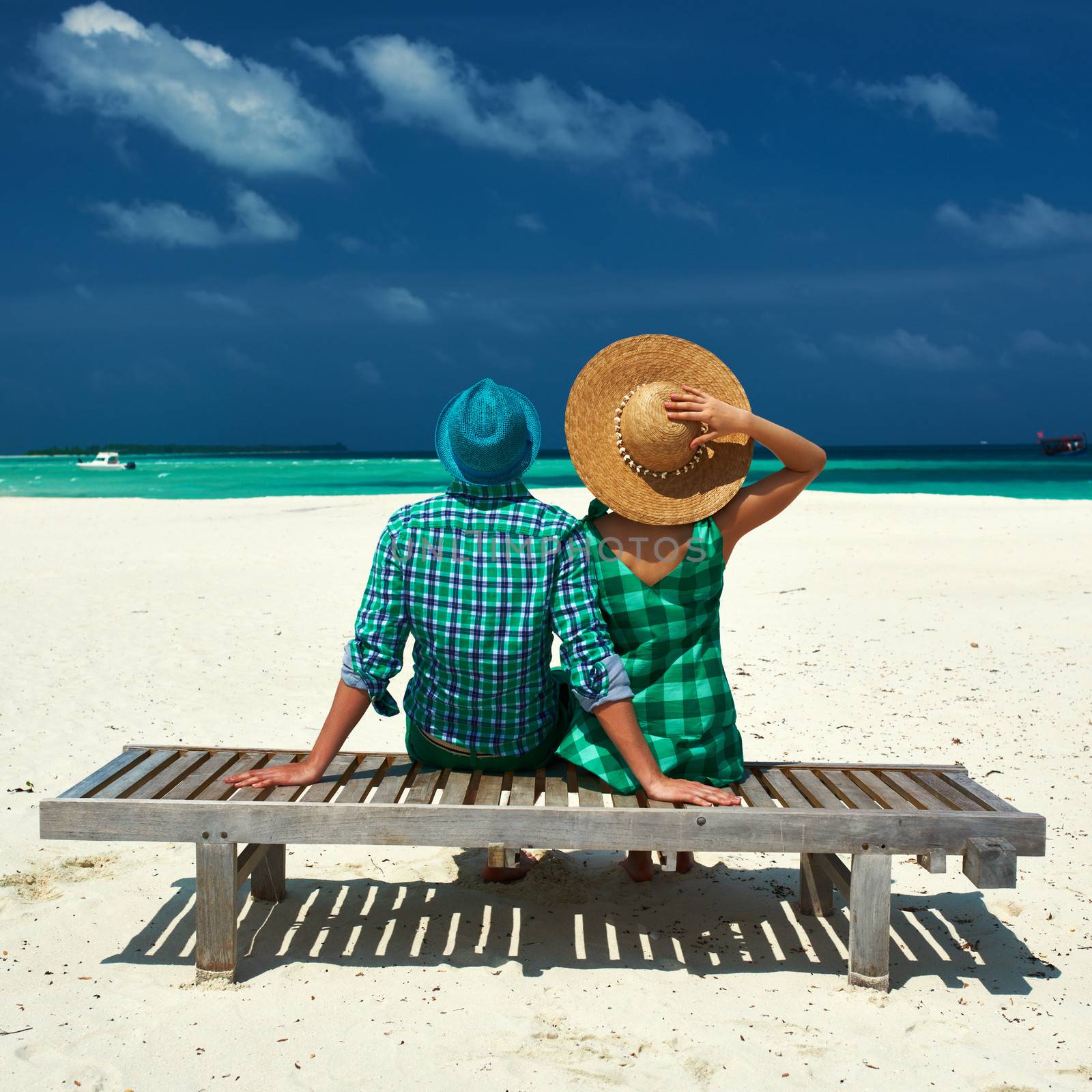 Couple in green on a tropical beach at Maldives