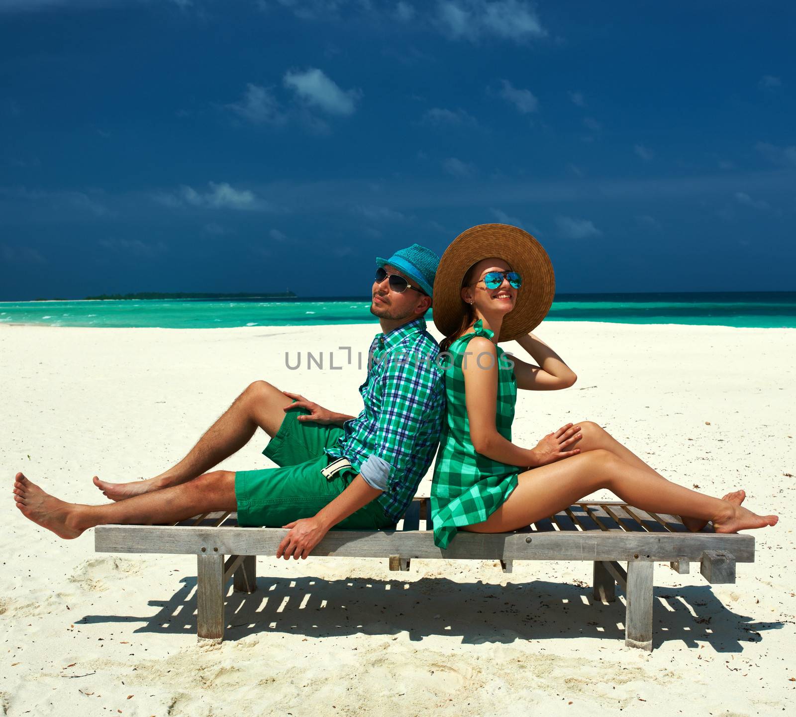Couple in green on a beach at Maldives by haveseen