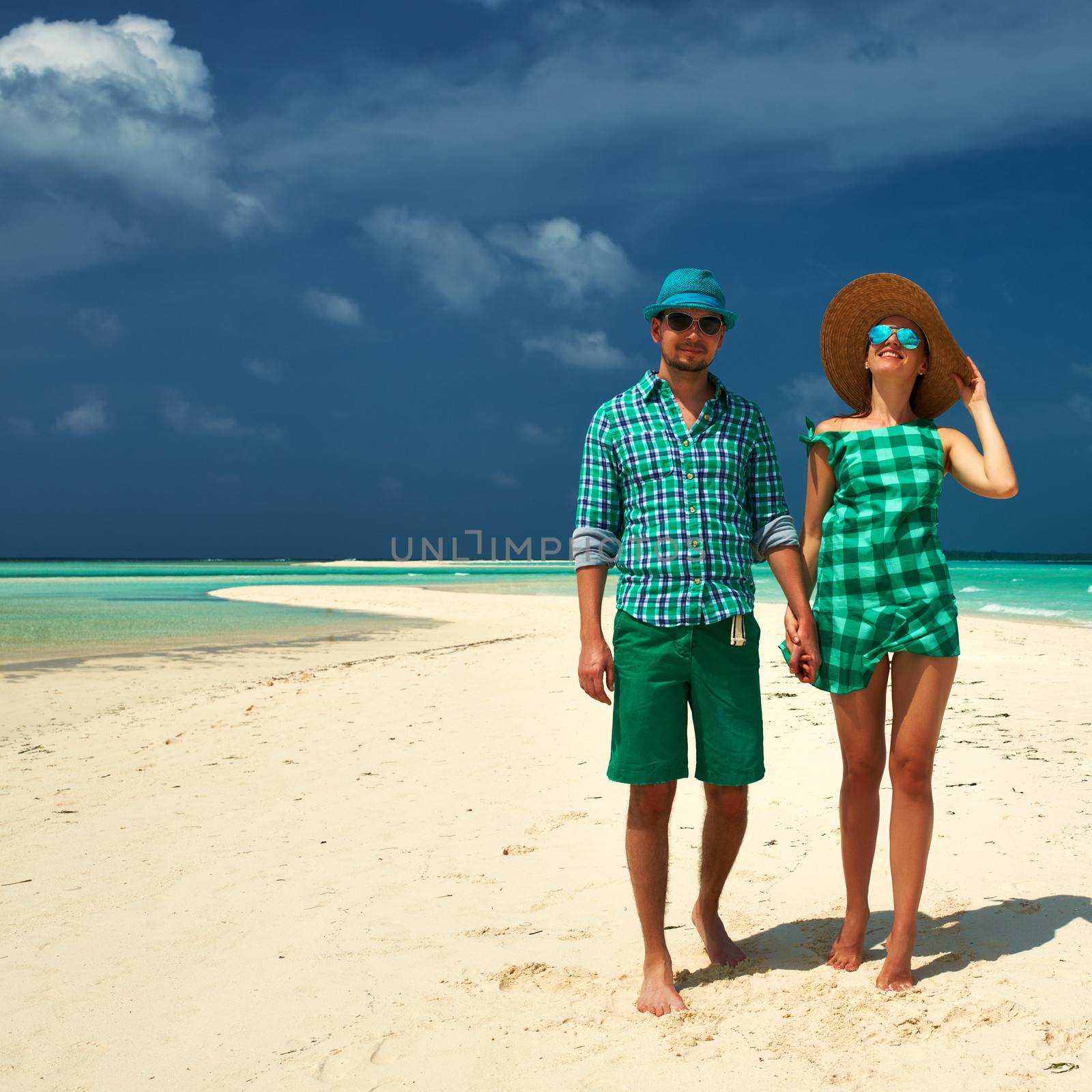 Couple in green on a tropical beach at Maldives