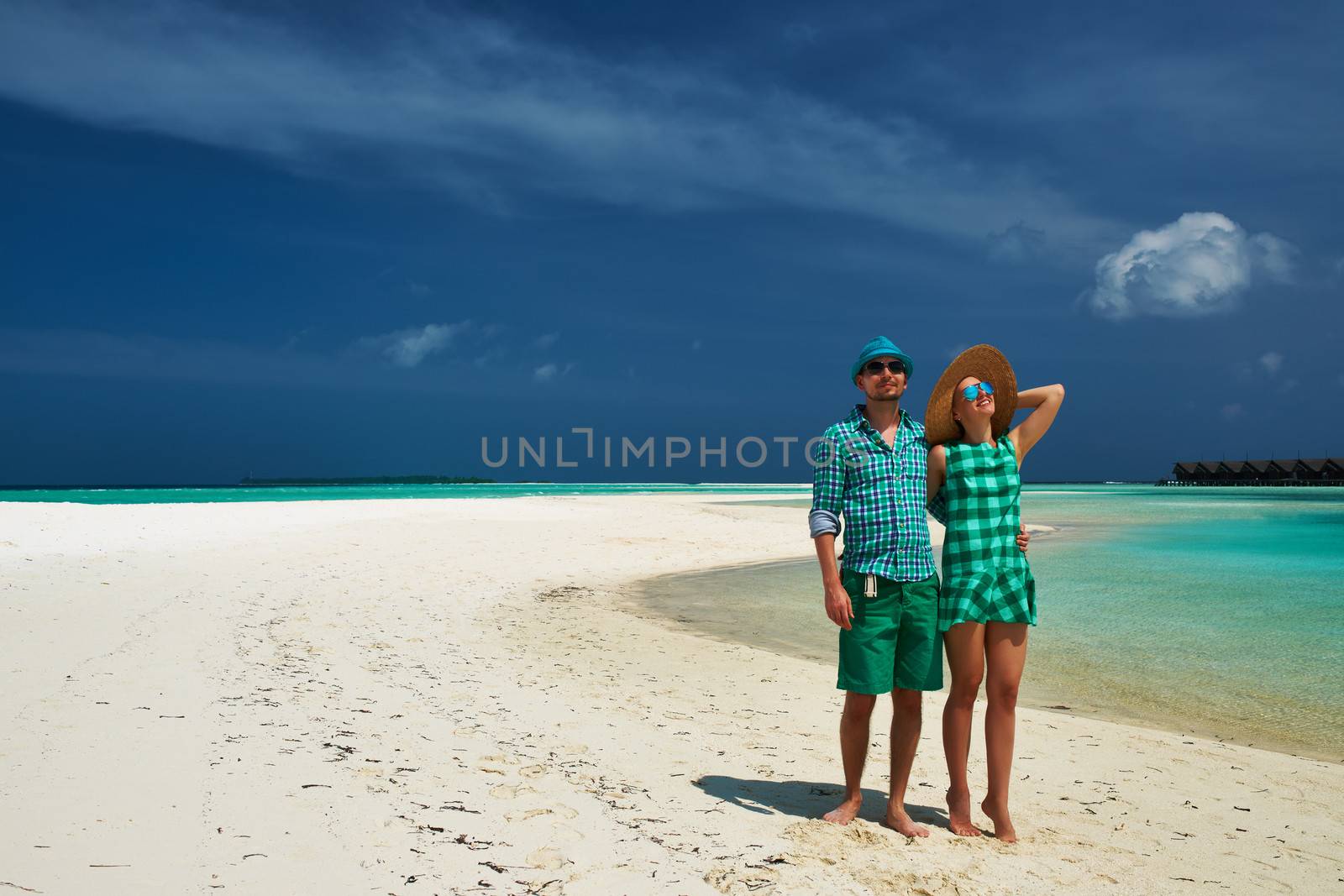 Couple in green on a beach at Maldives by haveseen