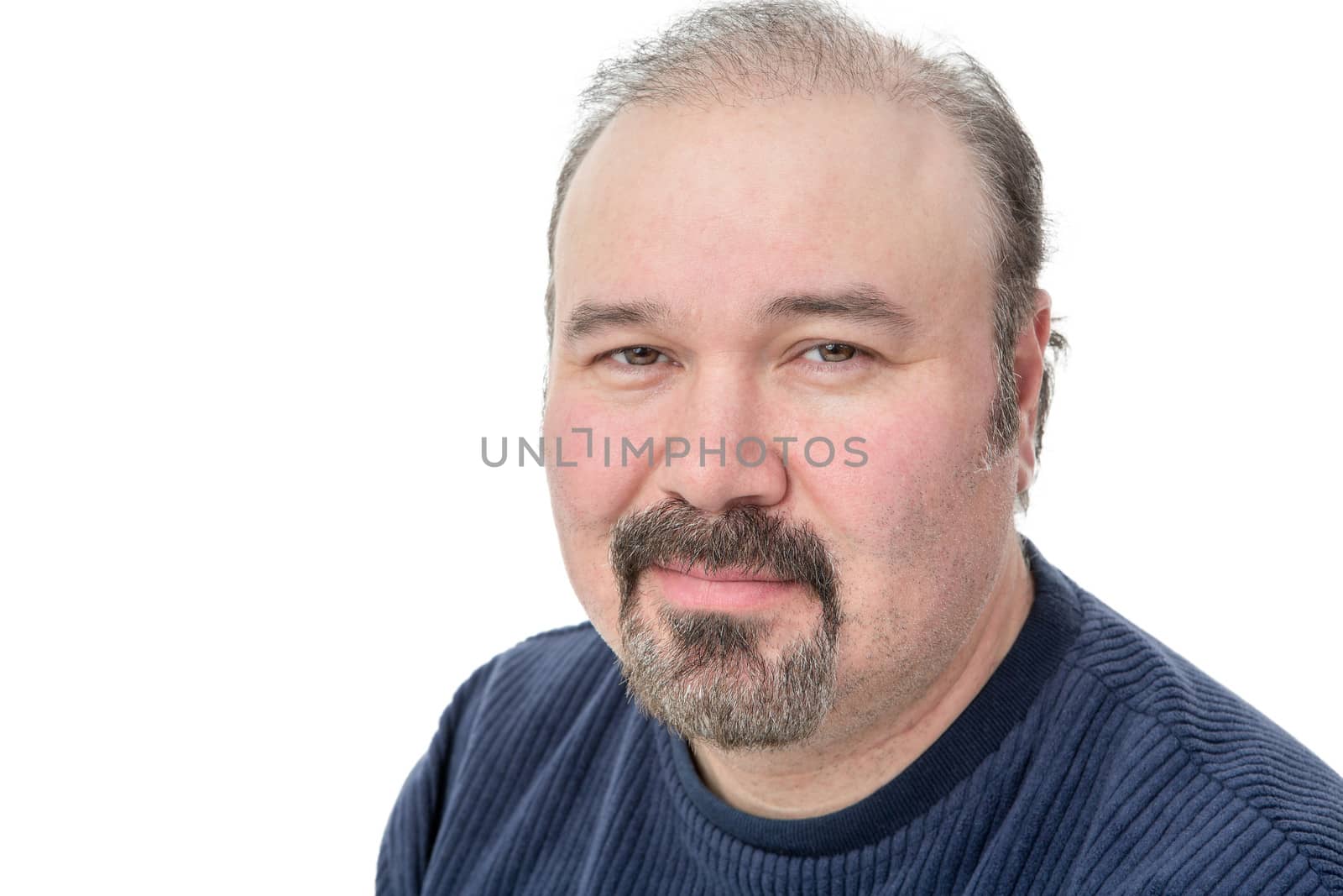 Closeup portrait of a middle-aged man with a speculative look looking pensively at the camera isolated on white