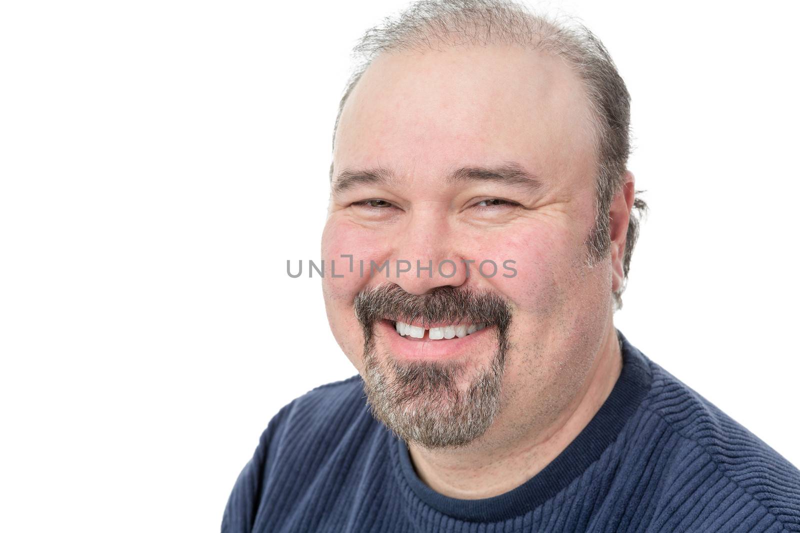 Closeup portrait of a middle-aged man with a goatee enjoying a good laugh smiling happily at the camera isolated on white with copyspace