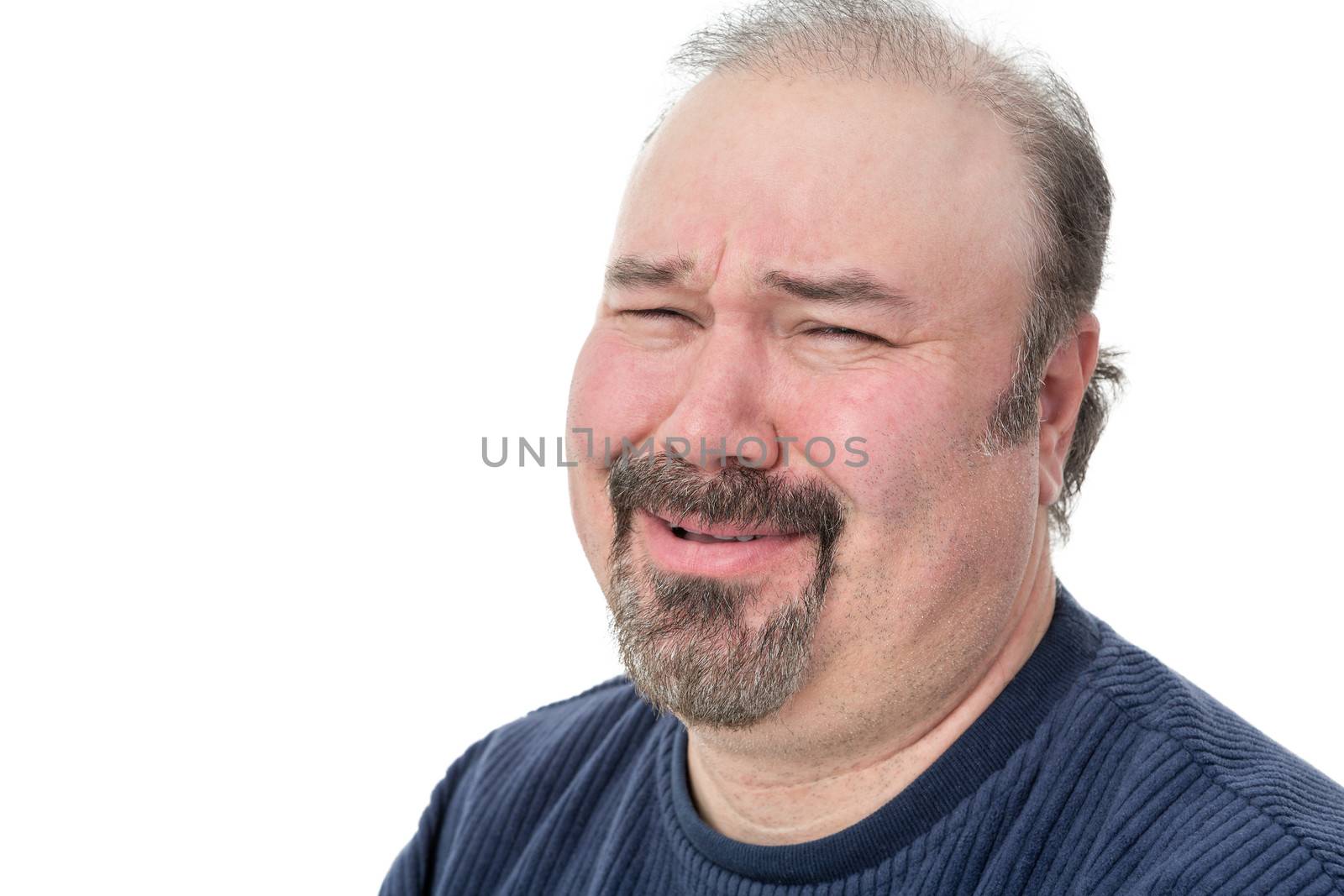 Close-up portrait of a man laughing with a disbelief expression